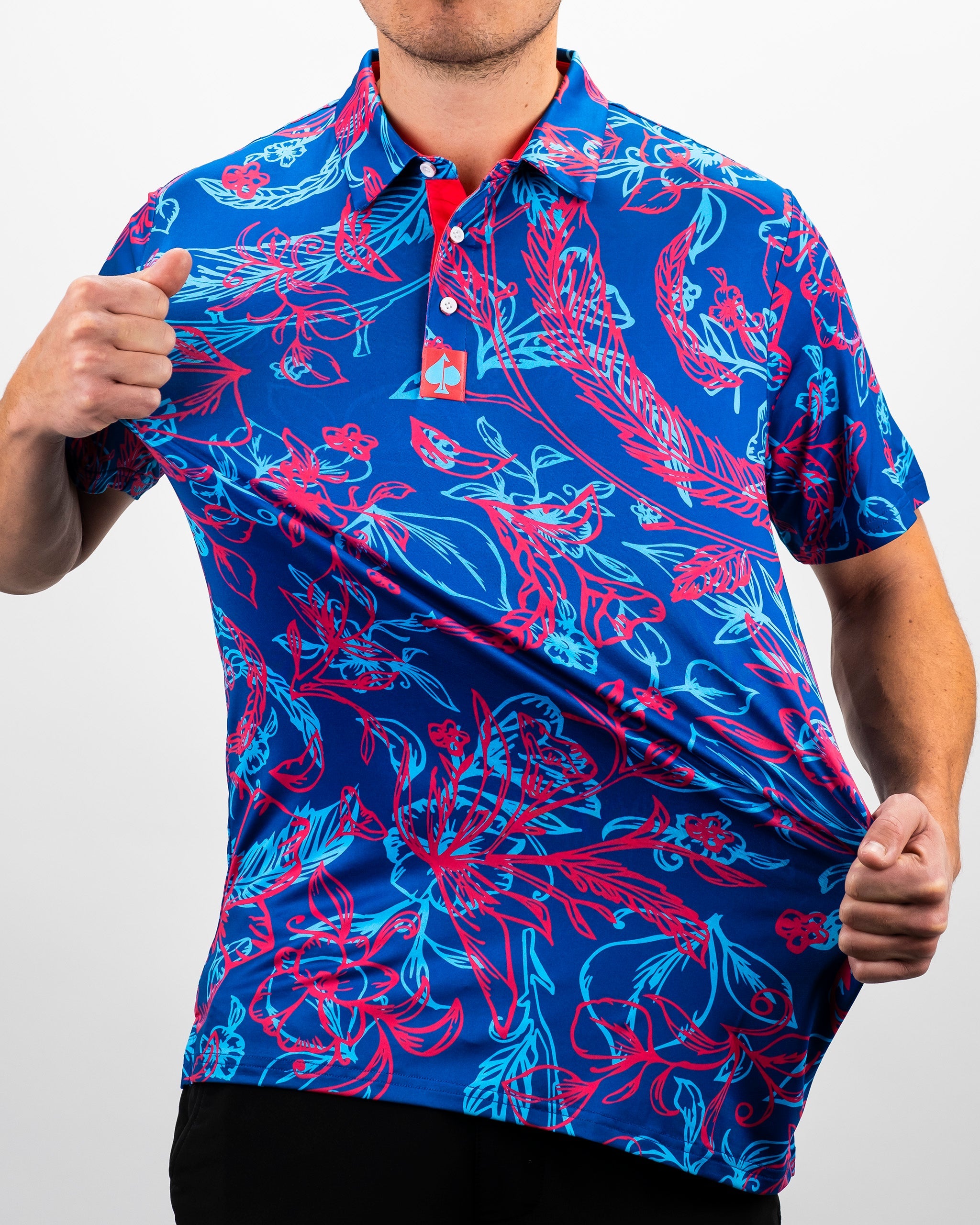Bold blue polo shirt featuring vibrant pink and turquoise floral patterns, perfect for golfers wanting to stand out on the course.