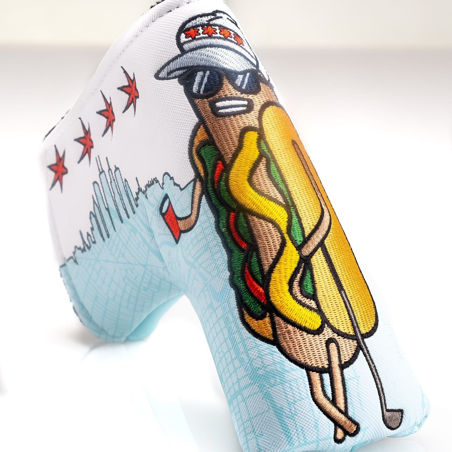Chicago Dog Blade Putter Cover featuring a fun hot dog character in sunglasses, holding a golf club against a city skyline.