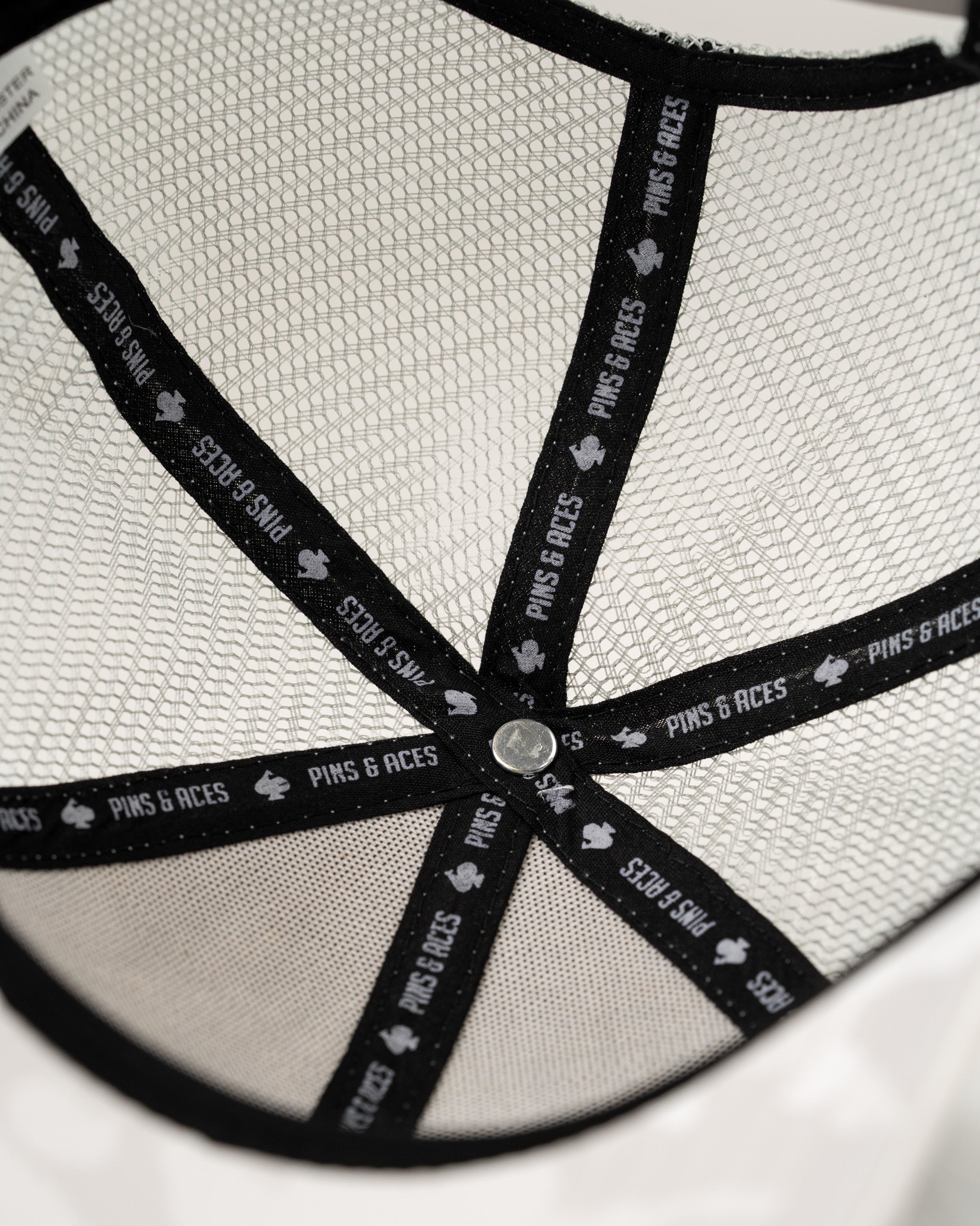 Interior view of the Arctic Camo trucker hat, showcasing the mesh lining and branded sweatband for comfort and style.