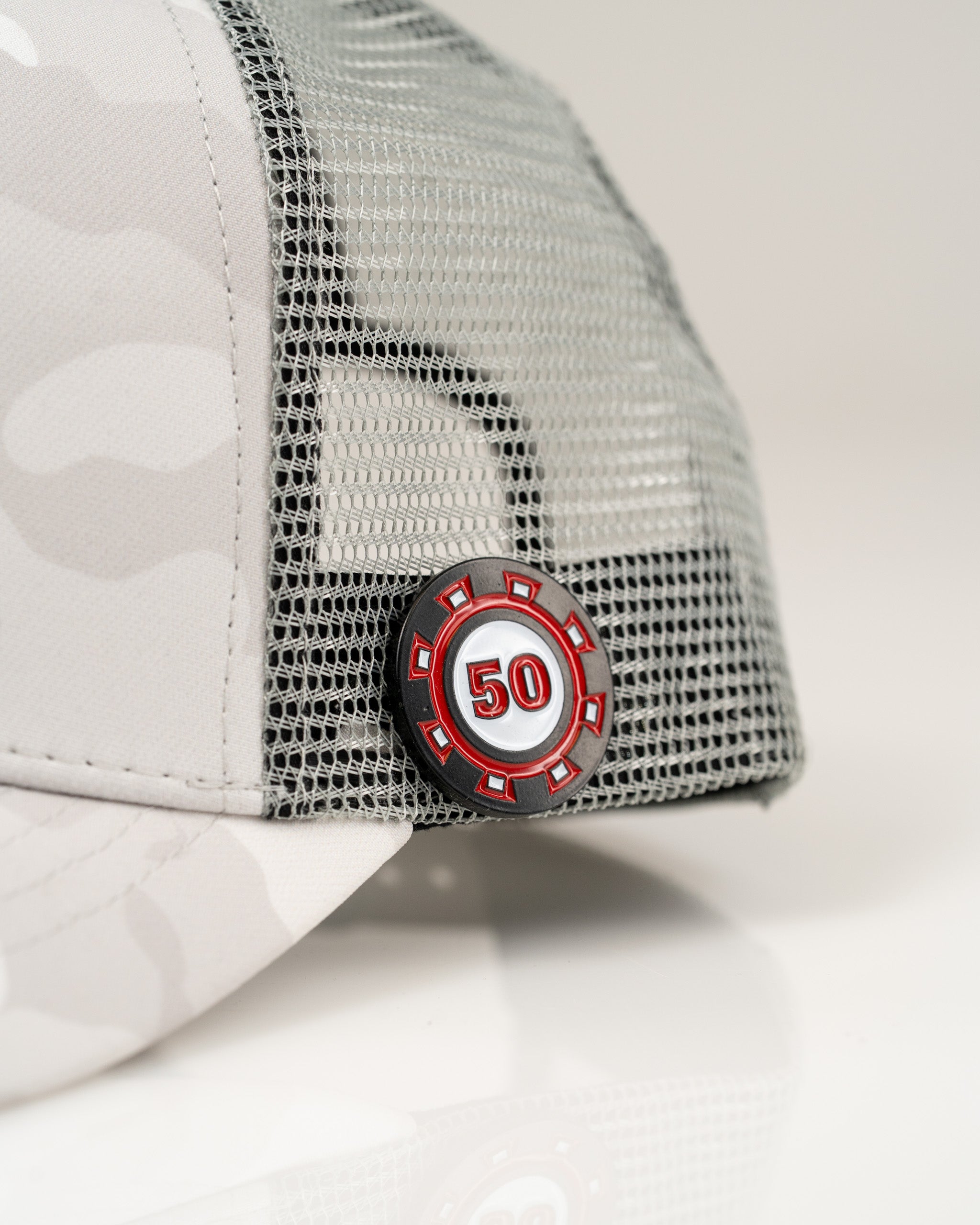 Trucker hat in Arctic Camo featuring a mesh back and a bold 50 emblem on the side for a stylish golf accessory.