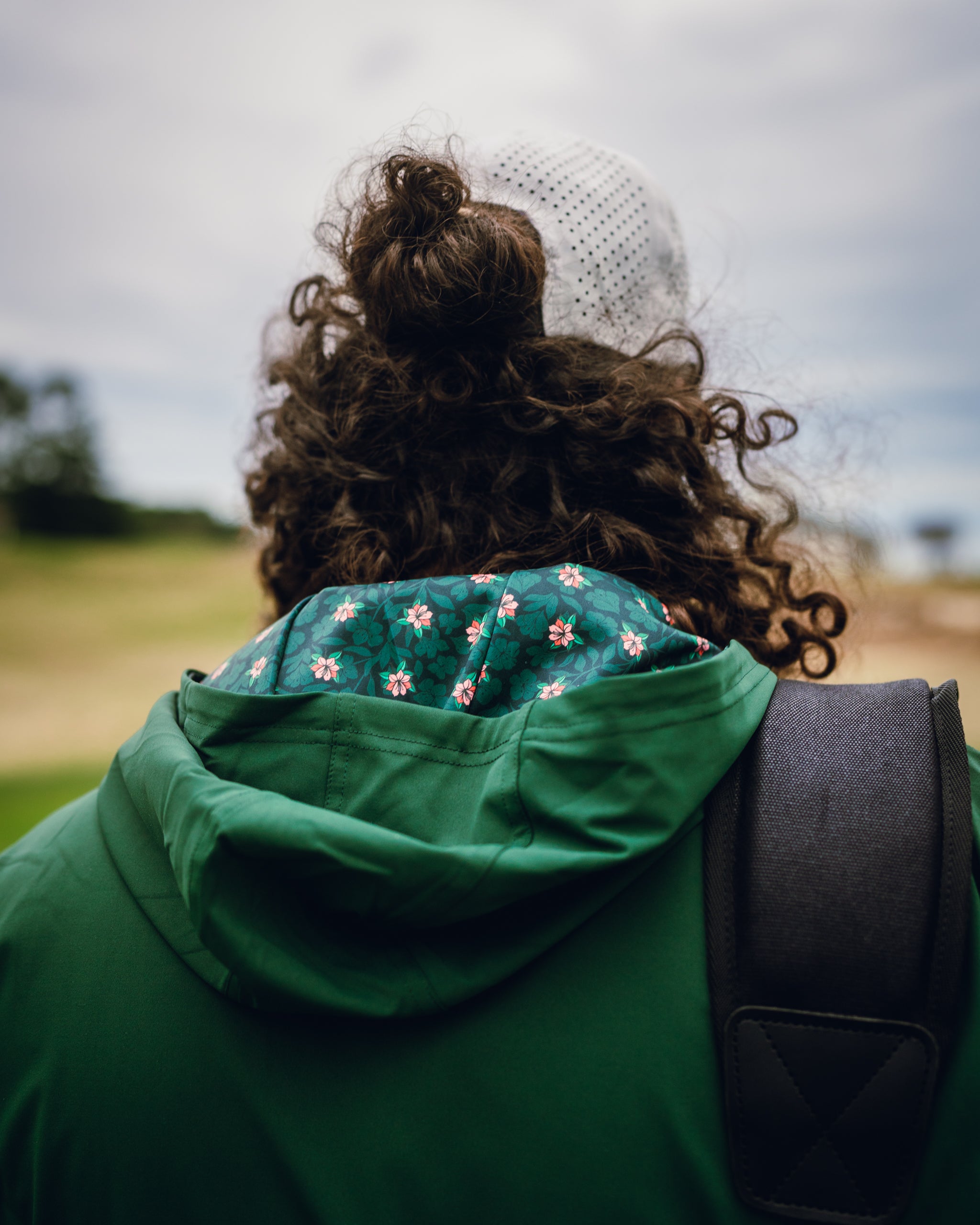 Performance Golf Hoodie in Dark Azalea features a floral-lined hood, perfect for stylish comfort on the golf course.