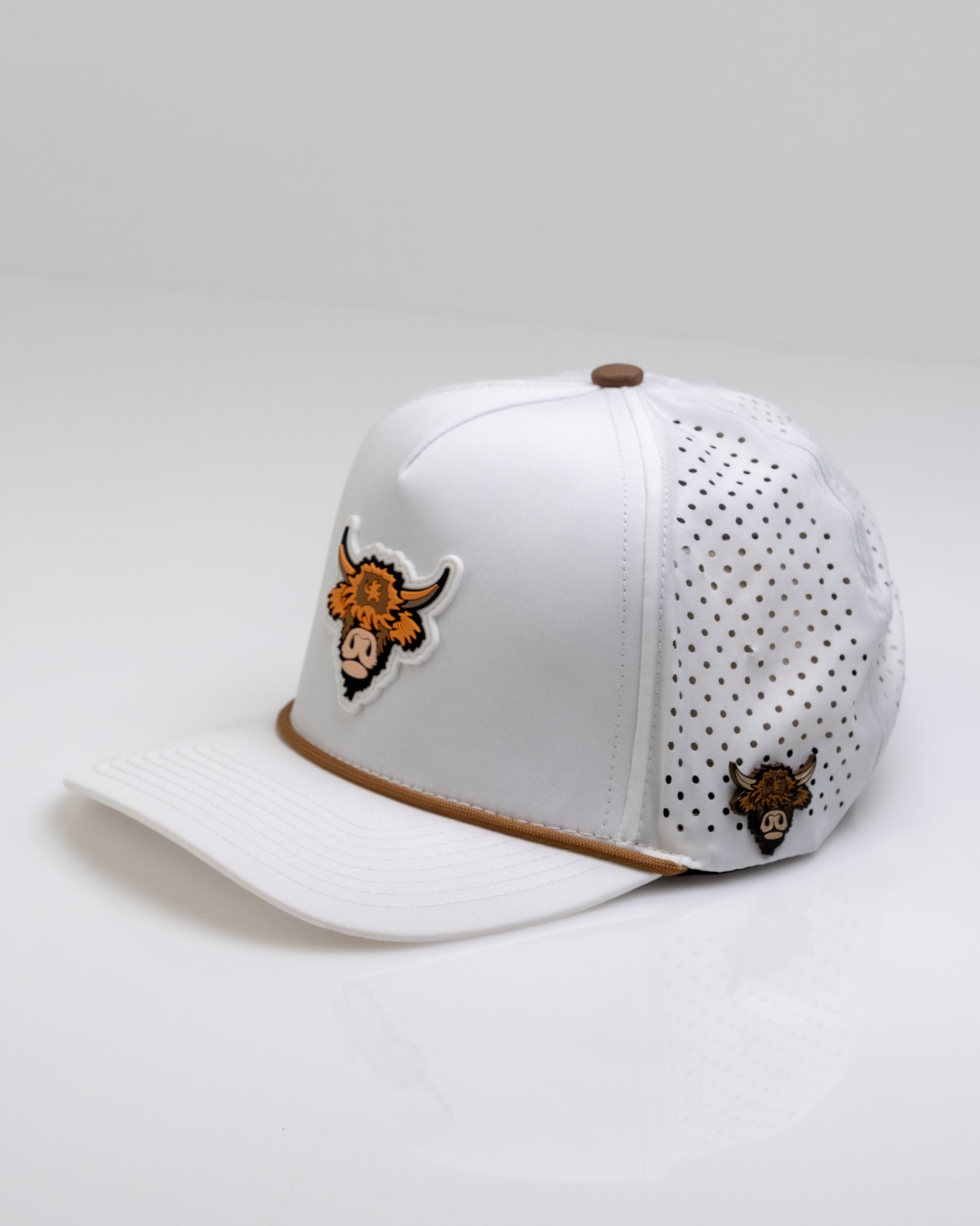 White perforated rope hat featuring a Highland cow design on the front and a smaller logo on the side.