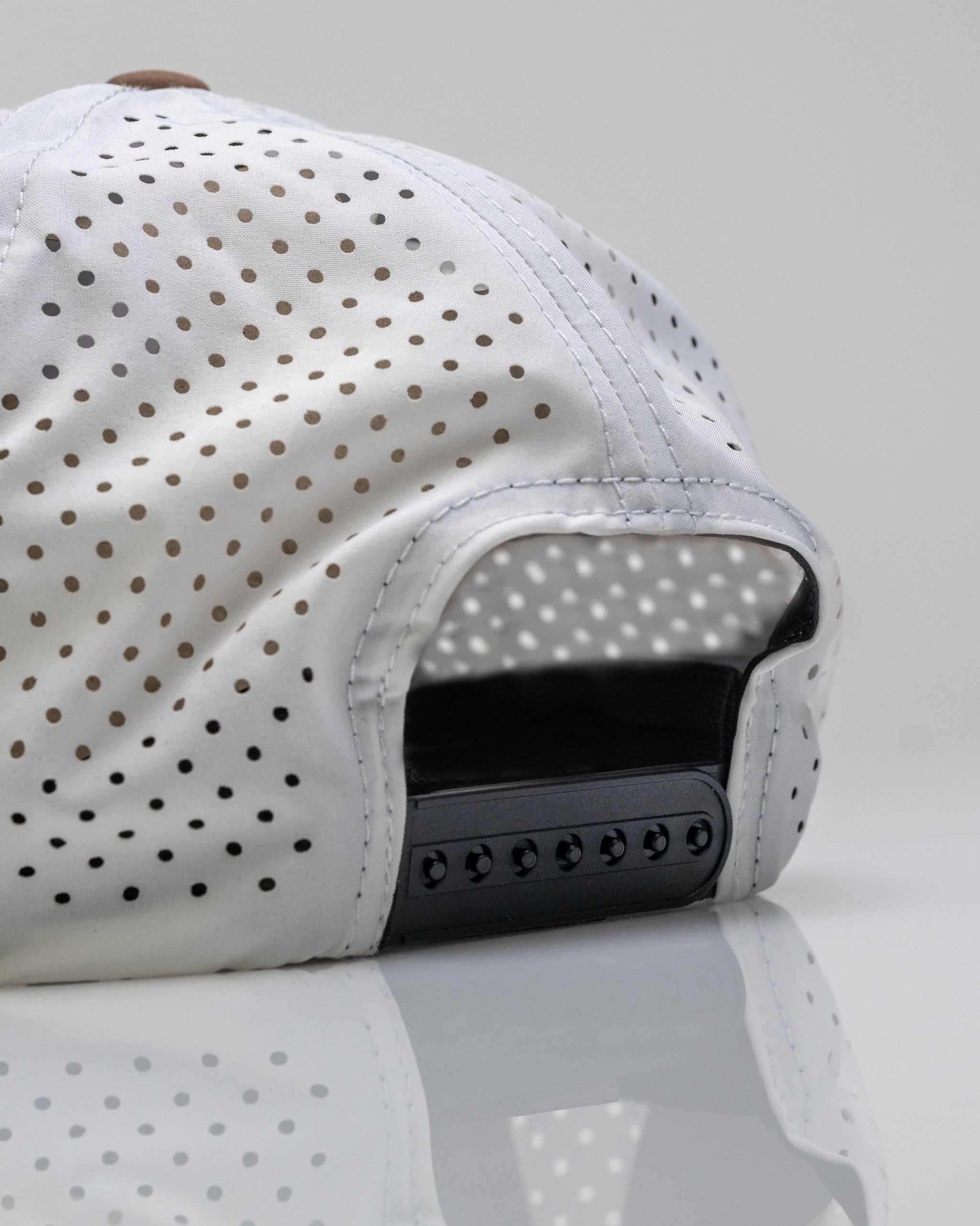 Perforated white rope hat featuring a Highland cow design, showcasing a sleek back with adjustable strap.