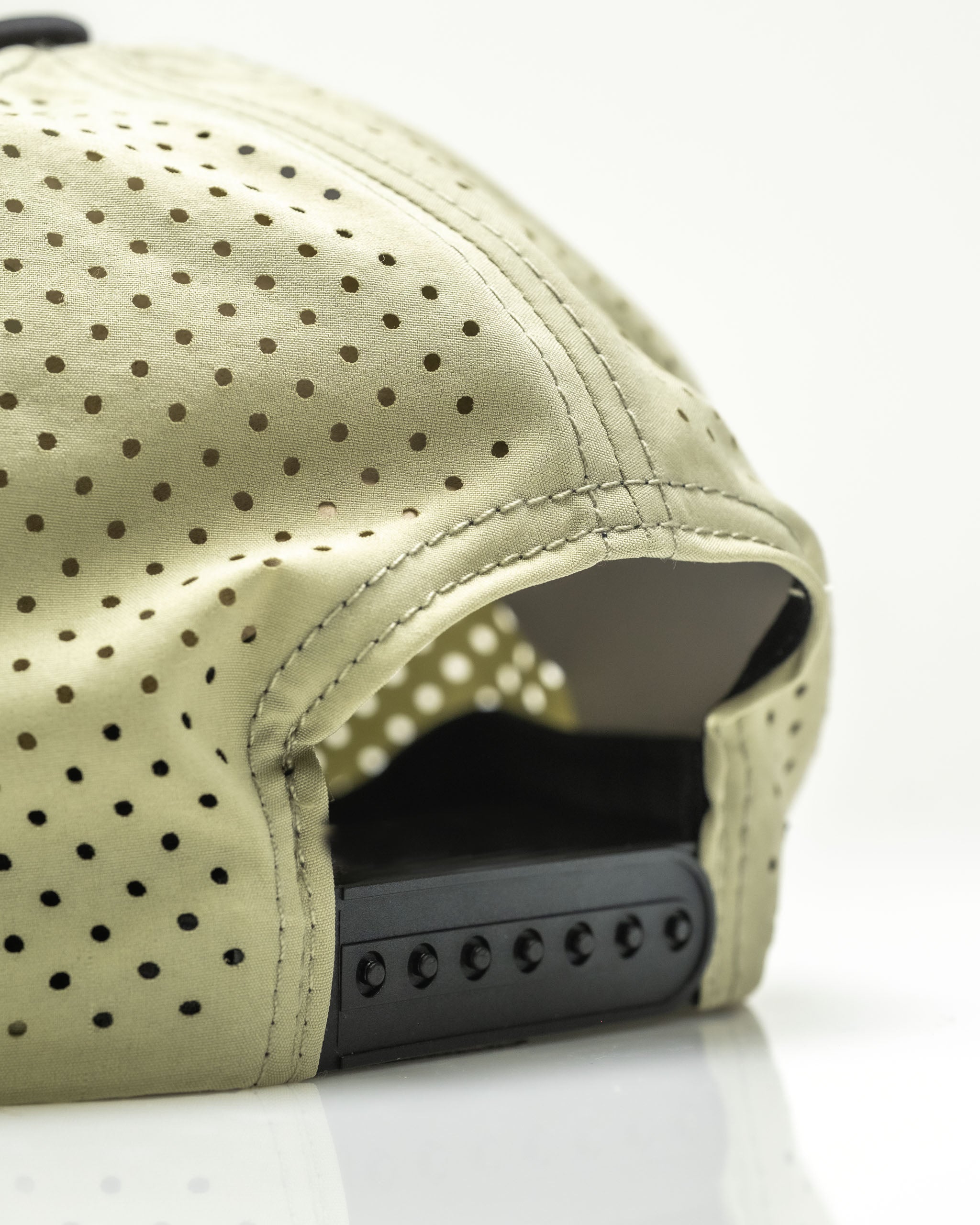 Perforated olive rope hat featuring a stylish design and adjustable snapback closure for a comfortable fit.