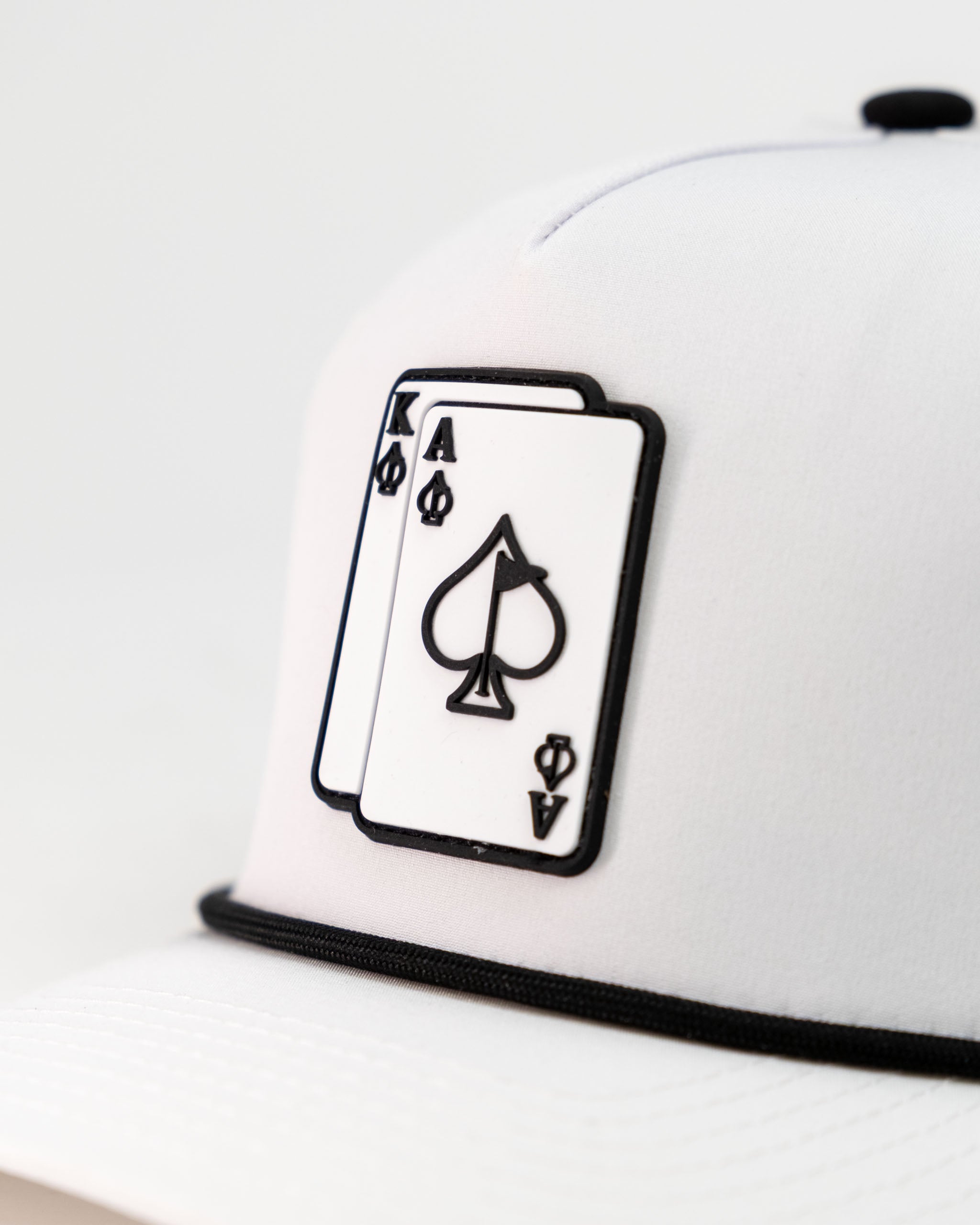 White perforated rope hat featuring a bold Ace and King playing card design for stylish golfers.