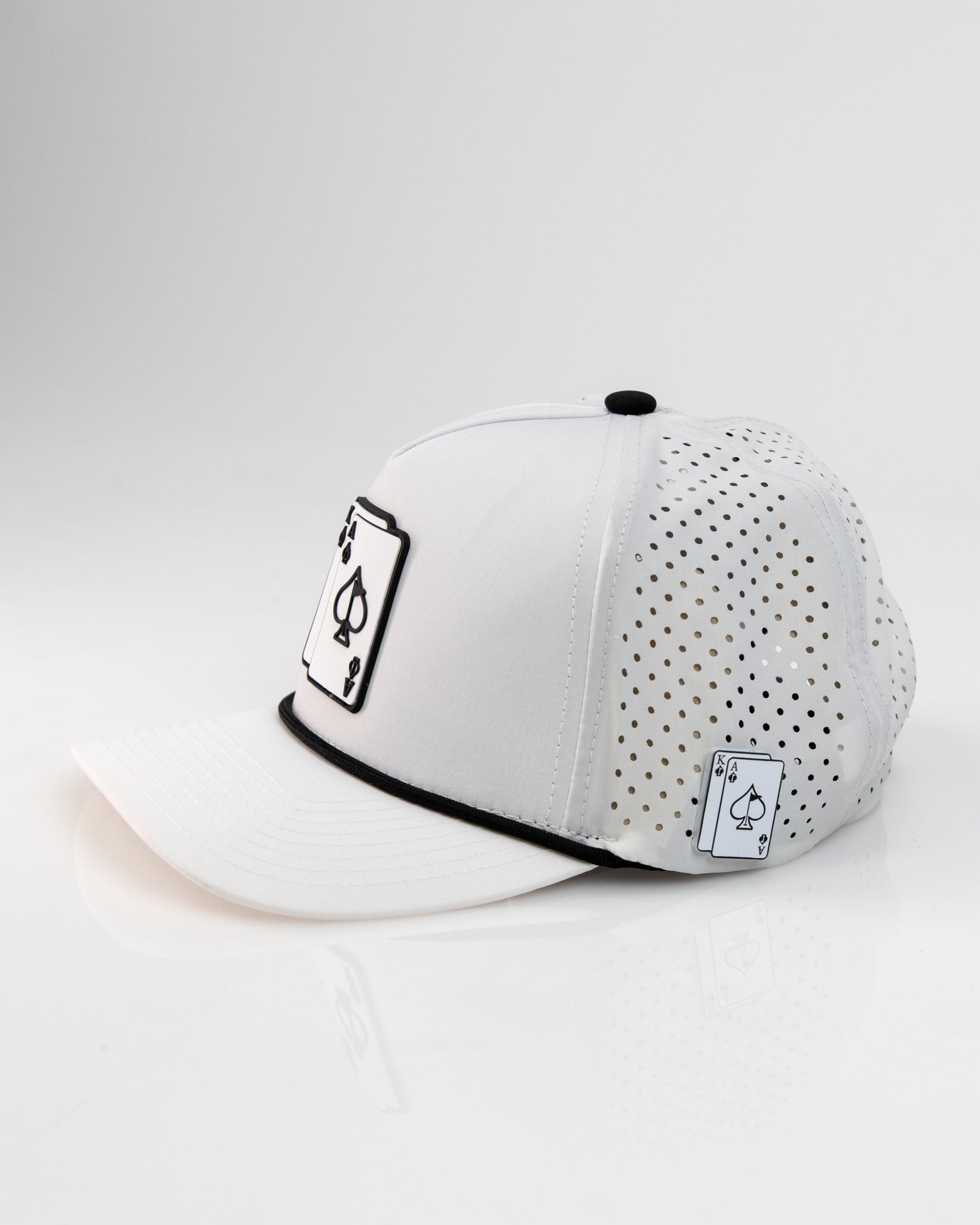 White perforated rope hat featuring Ace and King playing card designs, perfect for stylish golfers on the course.
