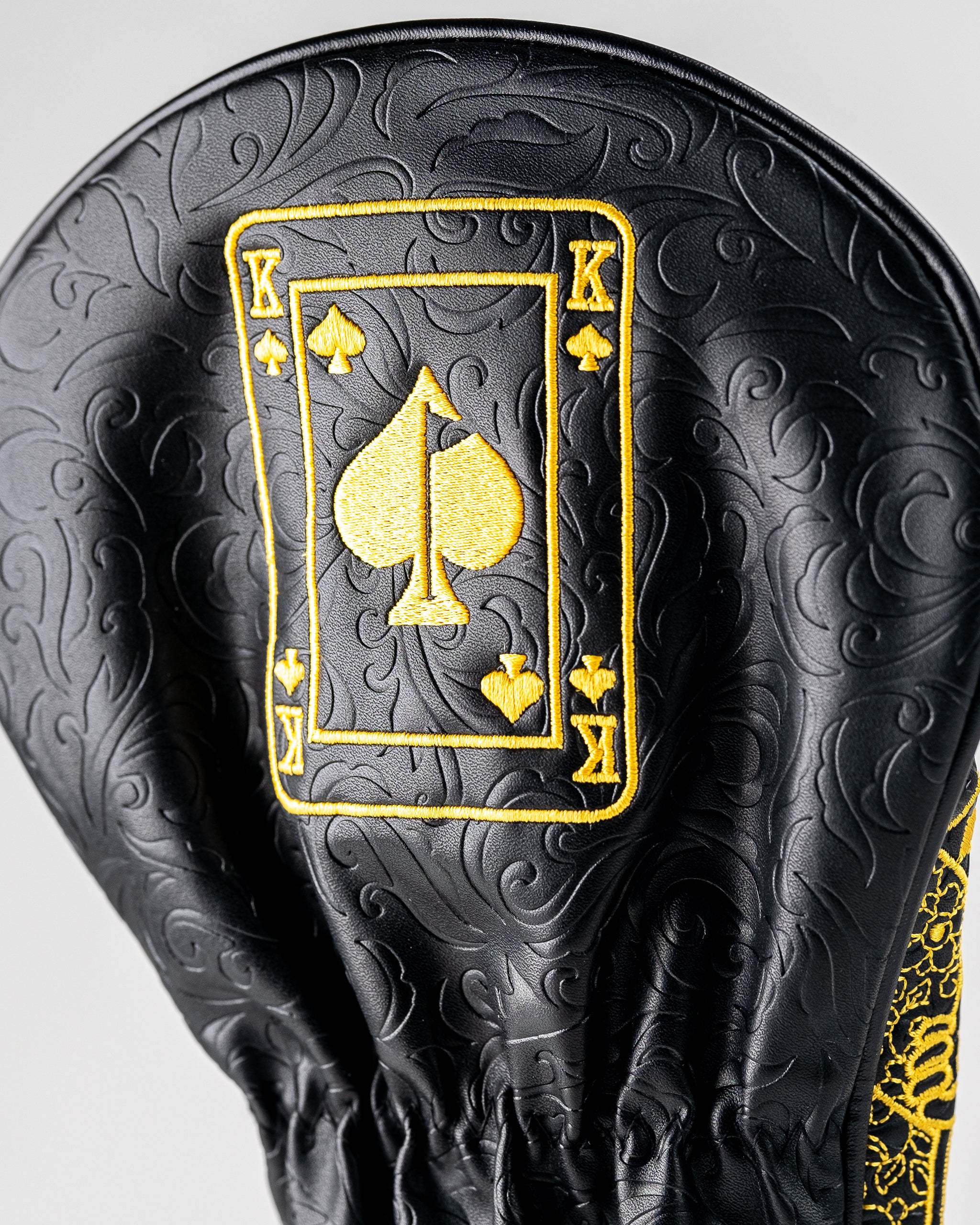 Black and gold King of Spades driver cover featuring a bold spade design, designed to protect golf clubs with style.