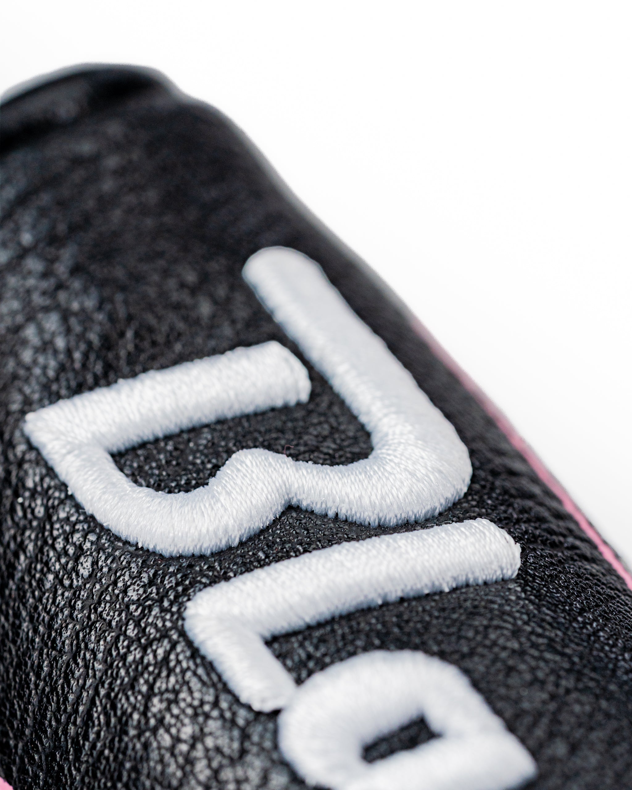 Black leather blade putter cover featuring bold white embroidery, designed for golfers seeking unique style on the course.