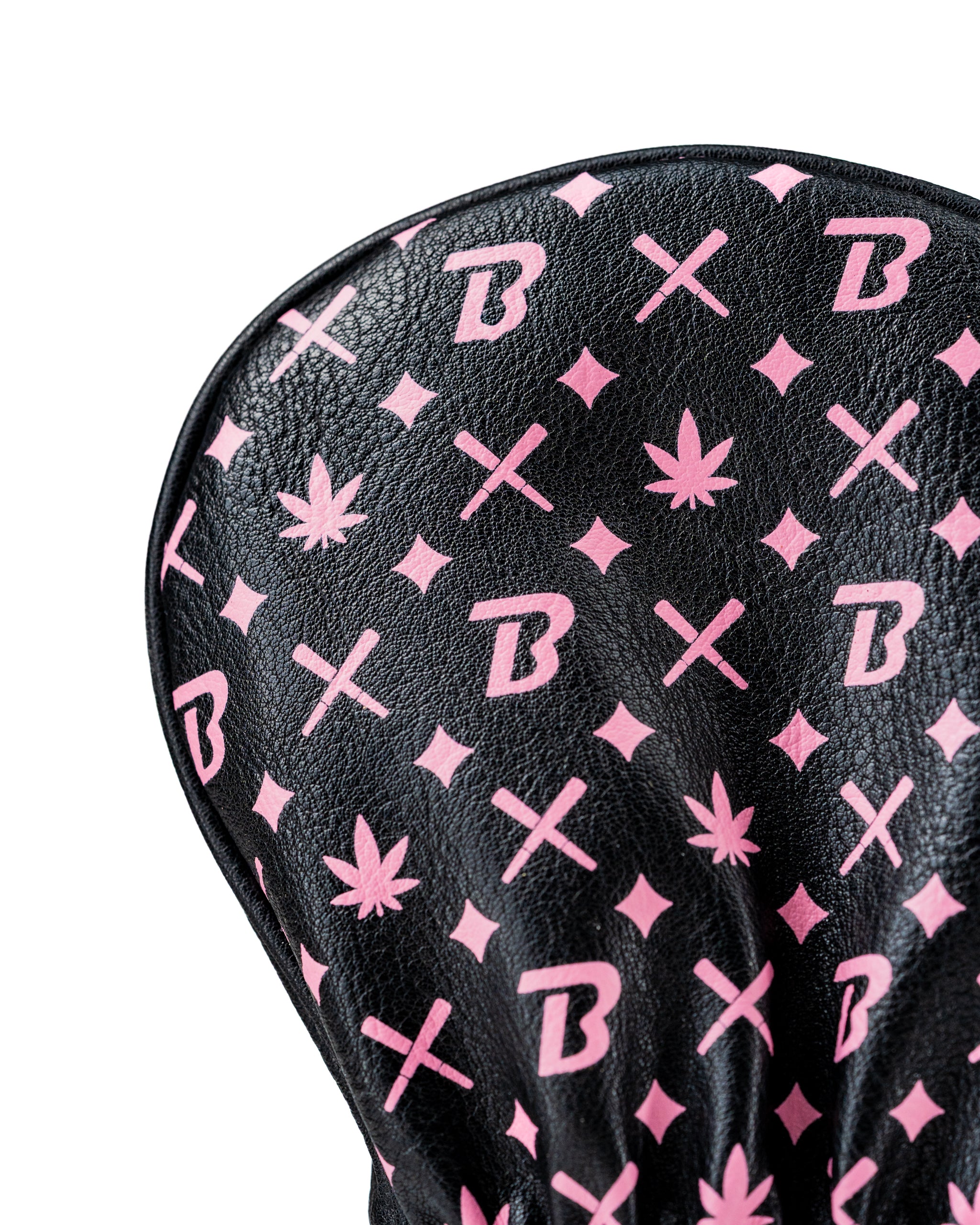 Bold black fairway cover featuring a unique pink pattern with symbols and logos, designed for stylish golfers.