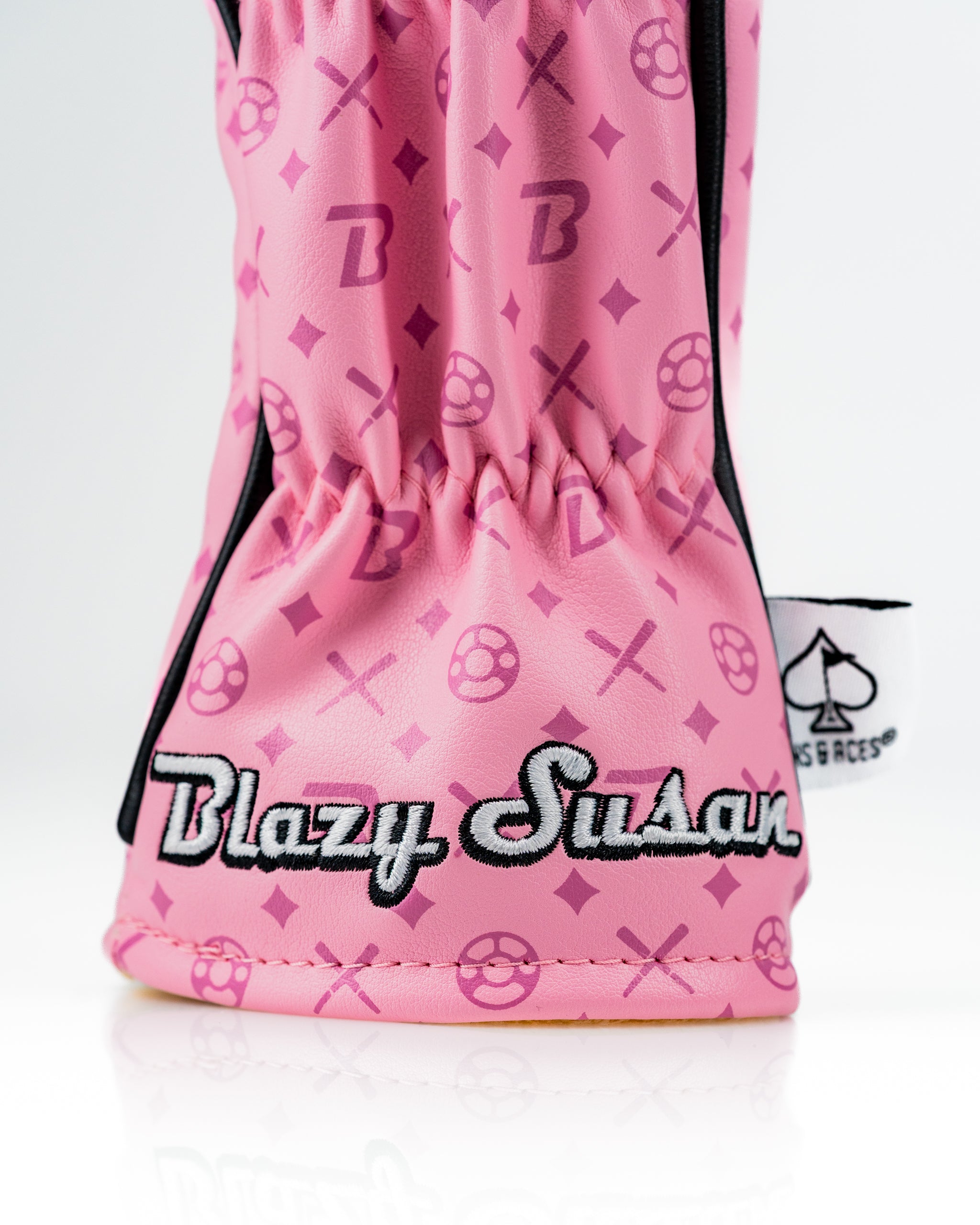 Bold pink hybrid golf cover featuring Blazy Susan branding and playful patterns, designed for stylish golfers.