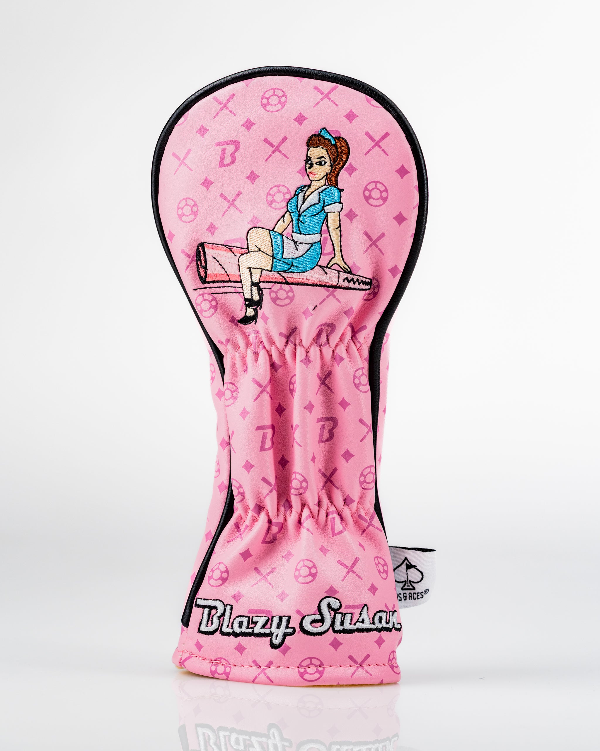 Bold pink hybrid golf cover featuring a playful design of a character sitting on a rolling pin, branded with Blazy Susan.