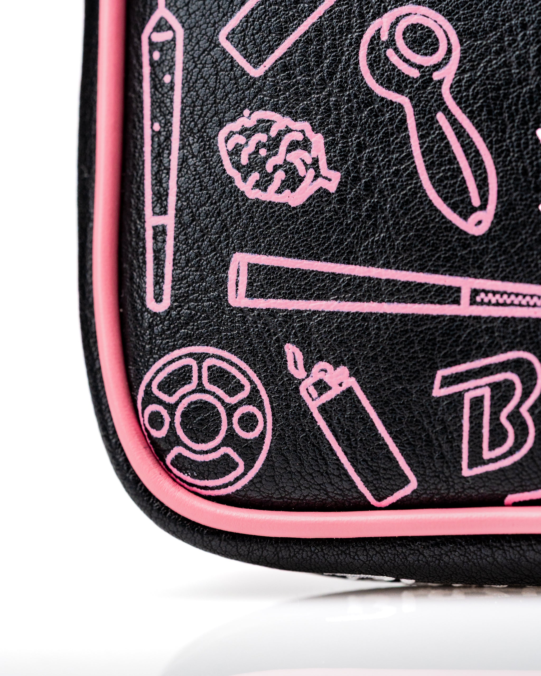Bold black mallet putter cover featuring playful pink graphics, perfect for golfers looking to stand out on the course.