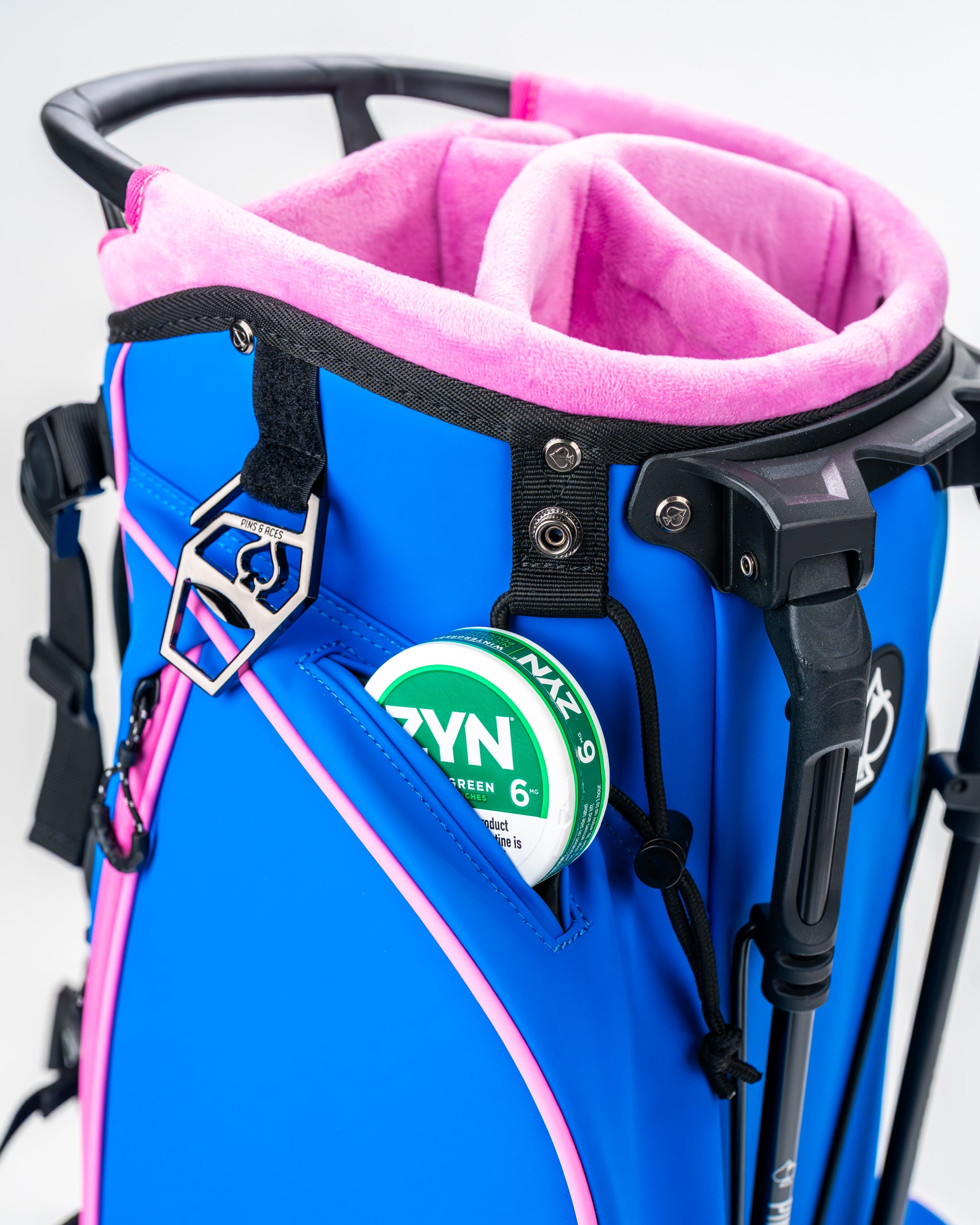 Blue Raspberry Player Preferred golf bag featuring a pink interior, multiple pockets, and a sleek design for golfers.