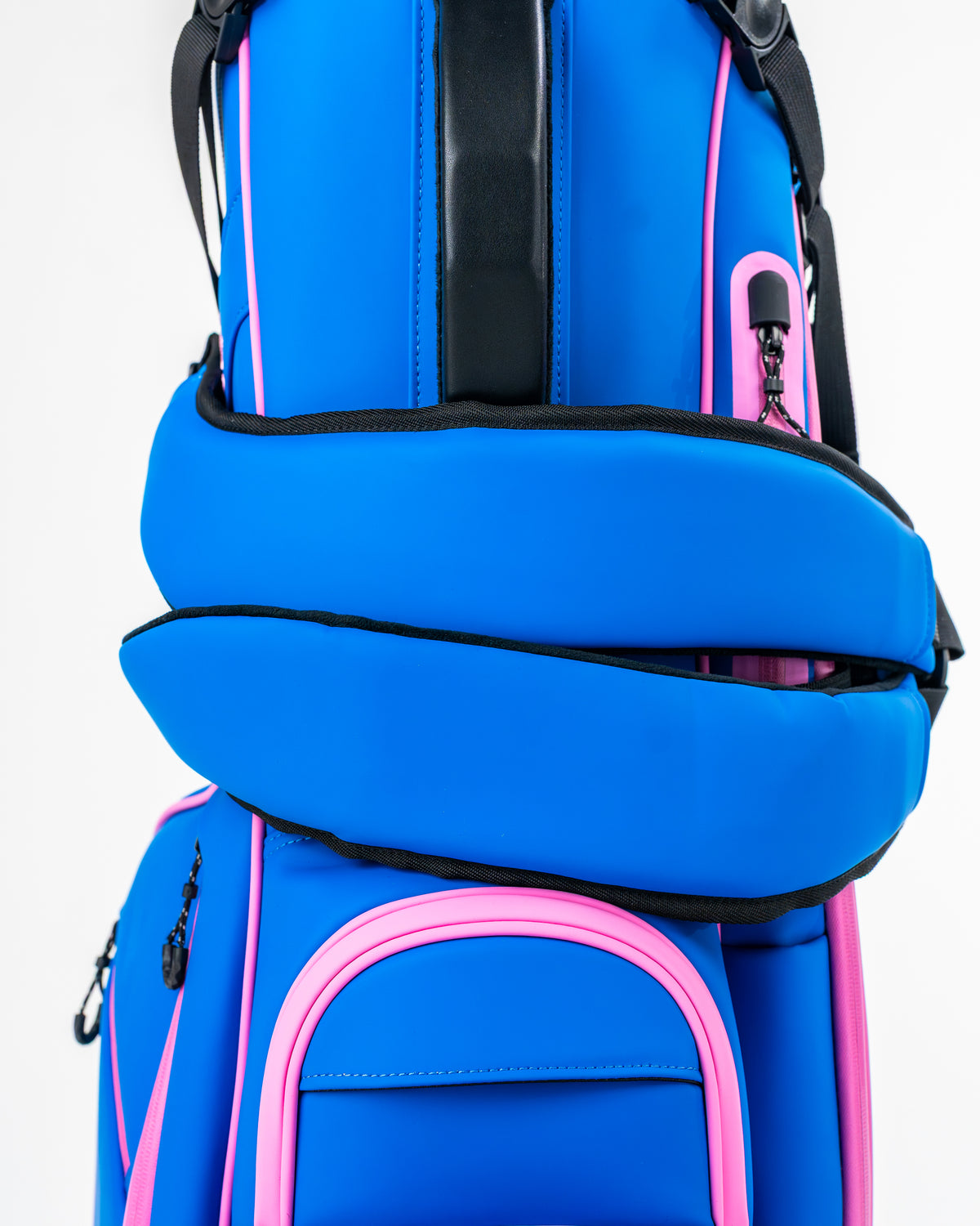 Bold blue raspberry golf bag with pink accents, featuring padded straps and multiple pockets for accessories.