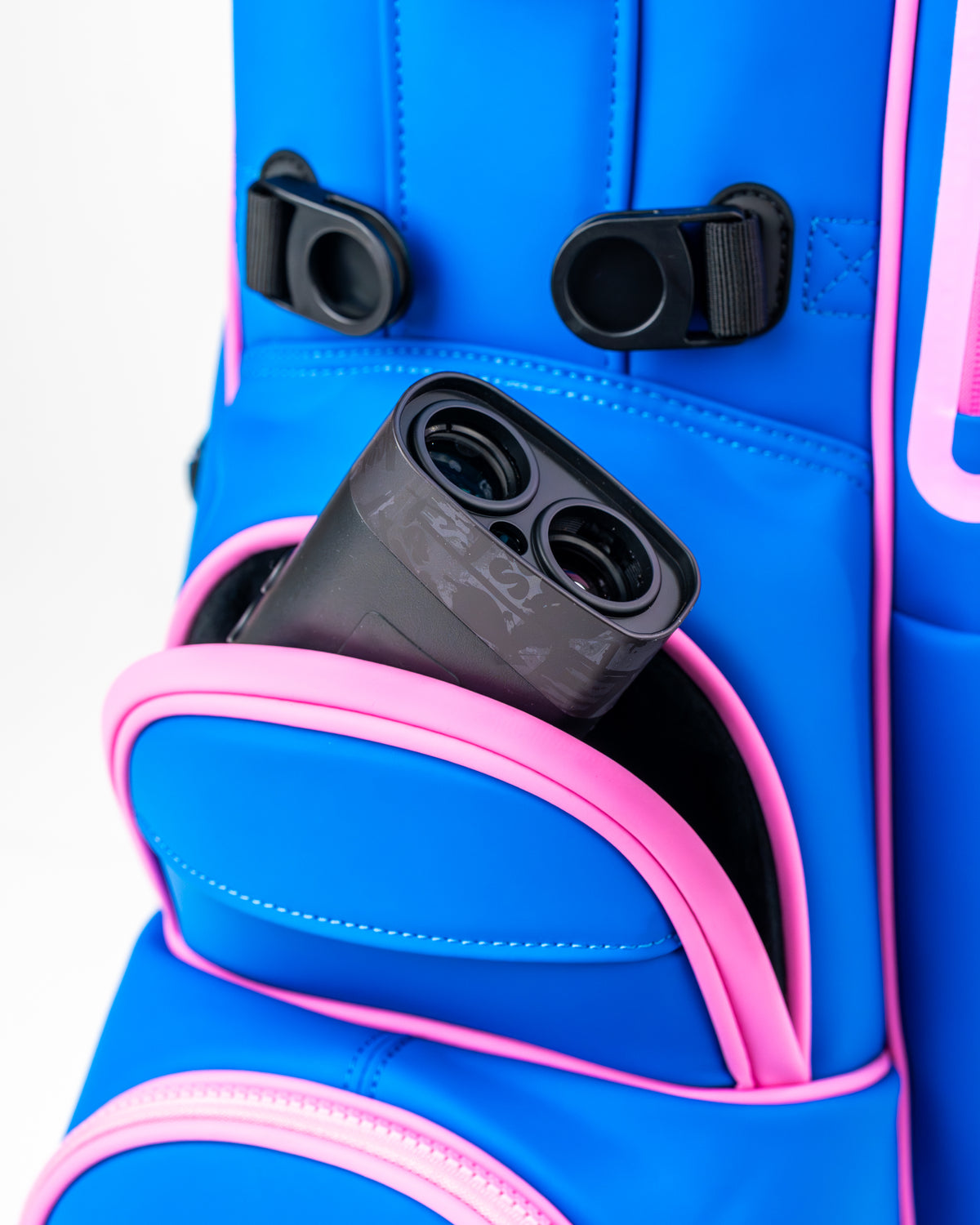 Blue Raspberry Player Preferred golf bag featuring a pink pocket with a golf rangefinder partially visible inside.