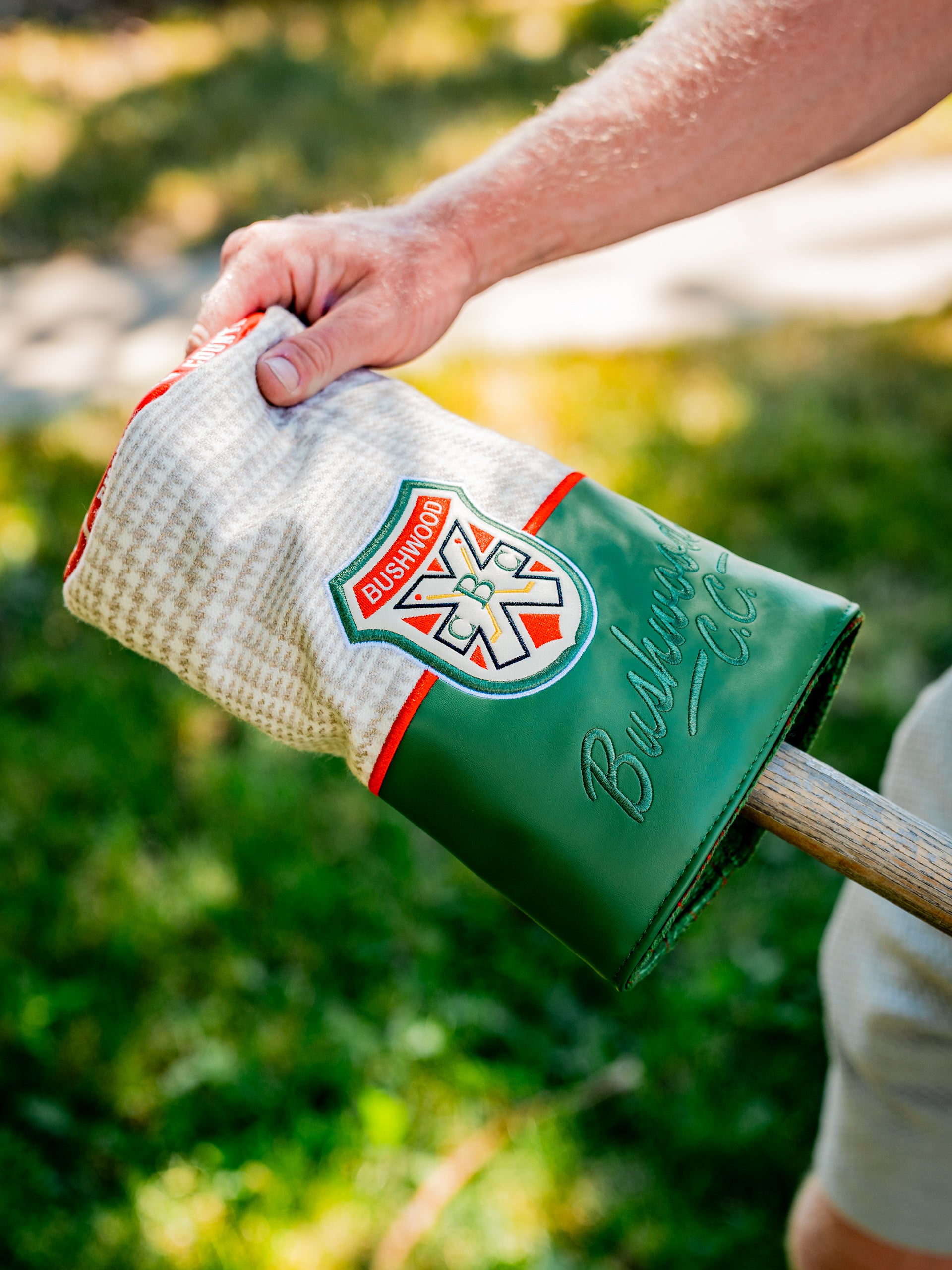 Bushwood CC driver cover featuring a green and white design with a logo, perfect for stylish protection on the golf course.