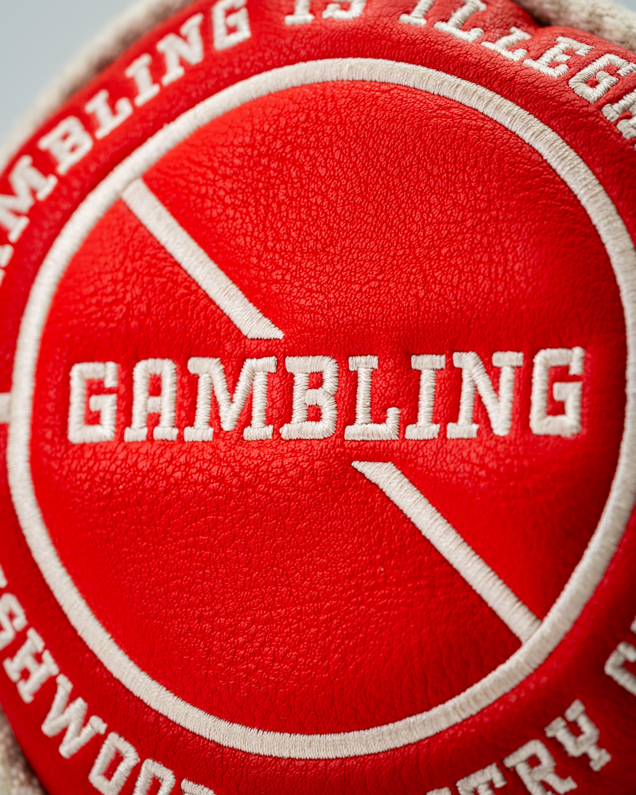 Bold red driver cover featuring the text "GAMBLING IS ILLEGAL" in white, designed for a unique golf experience.