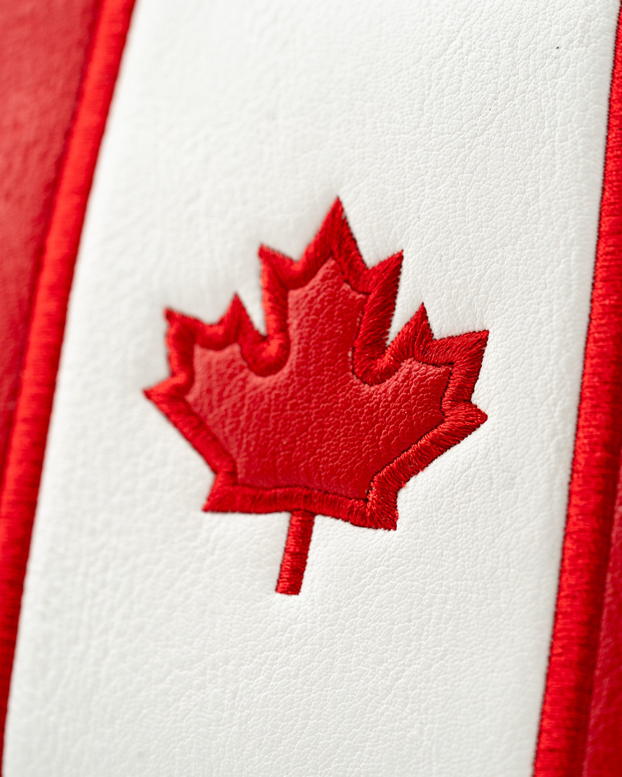 Red and white mallet putter cover featuring an embroidered Canadian maple leaf design, perfect for patriotic golfers.