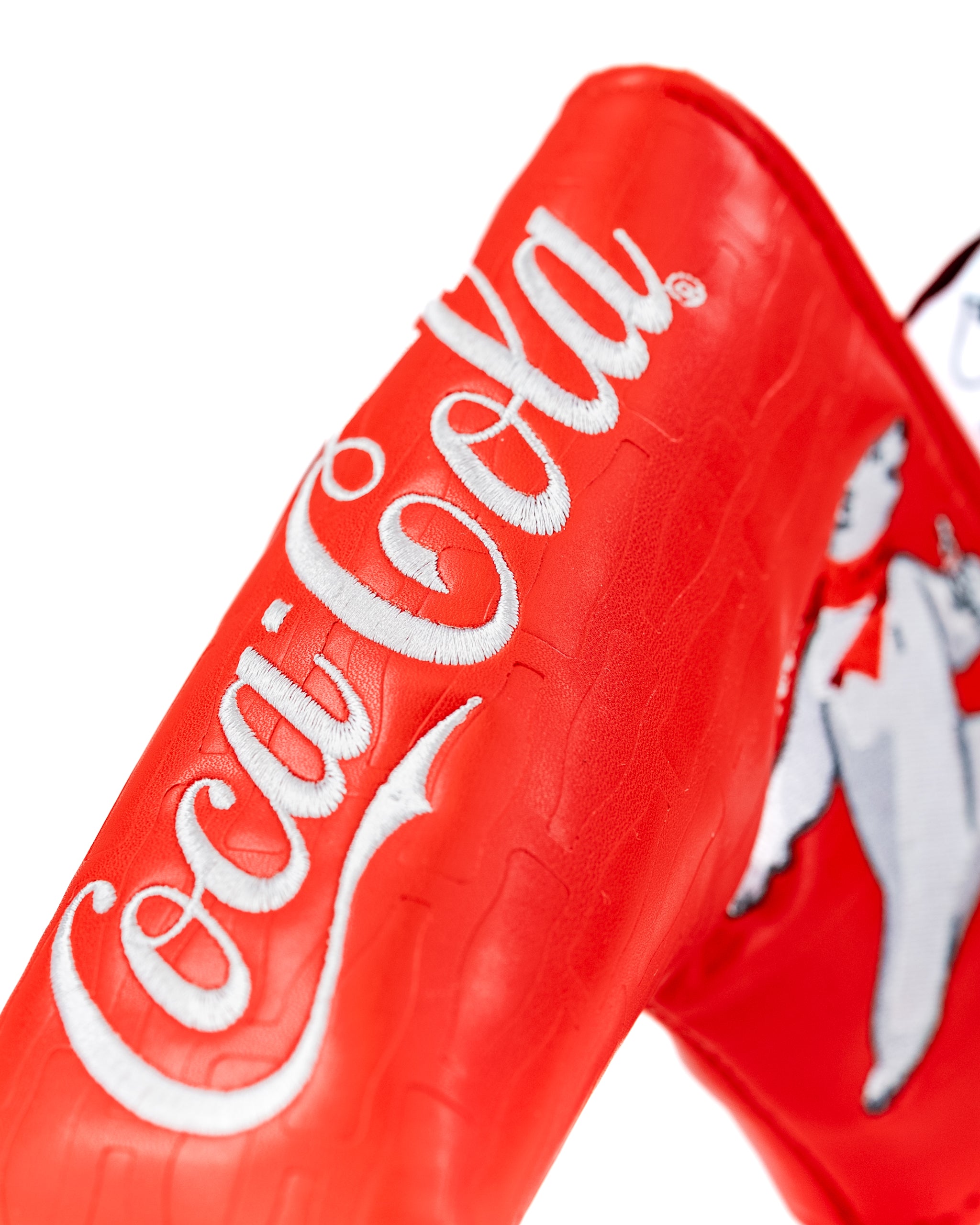 Coca-Cola Blade Putter Cover featuring a vibrant red design with embroidered logo and playful mascot detail.