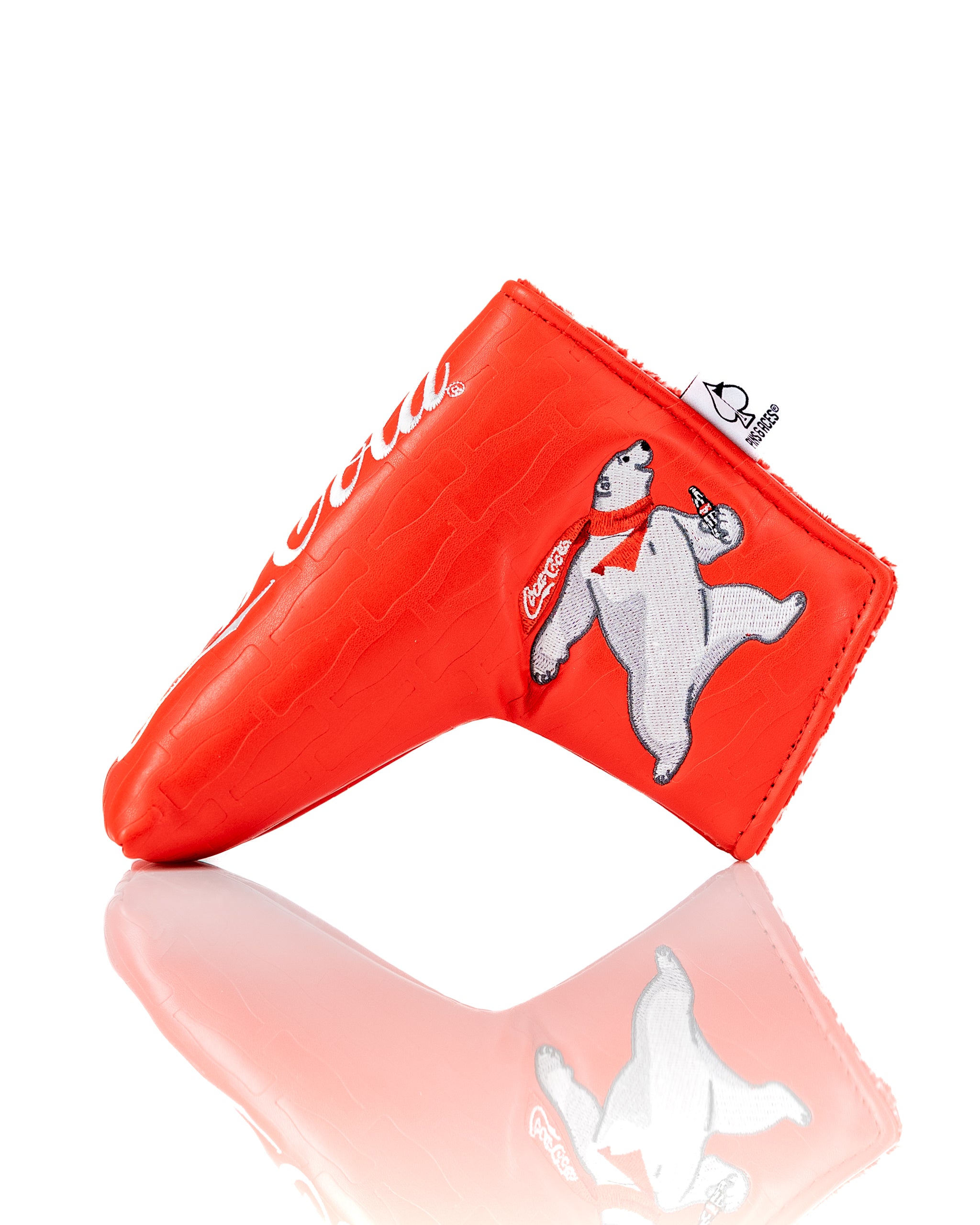 Coca-Cola themed blade putter cover in bright red with a polar bear design, perfect for stylish golfers.