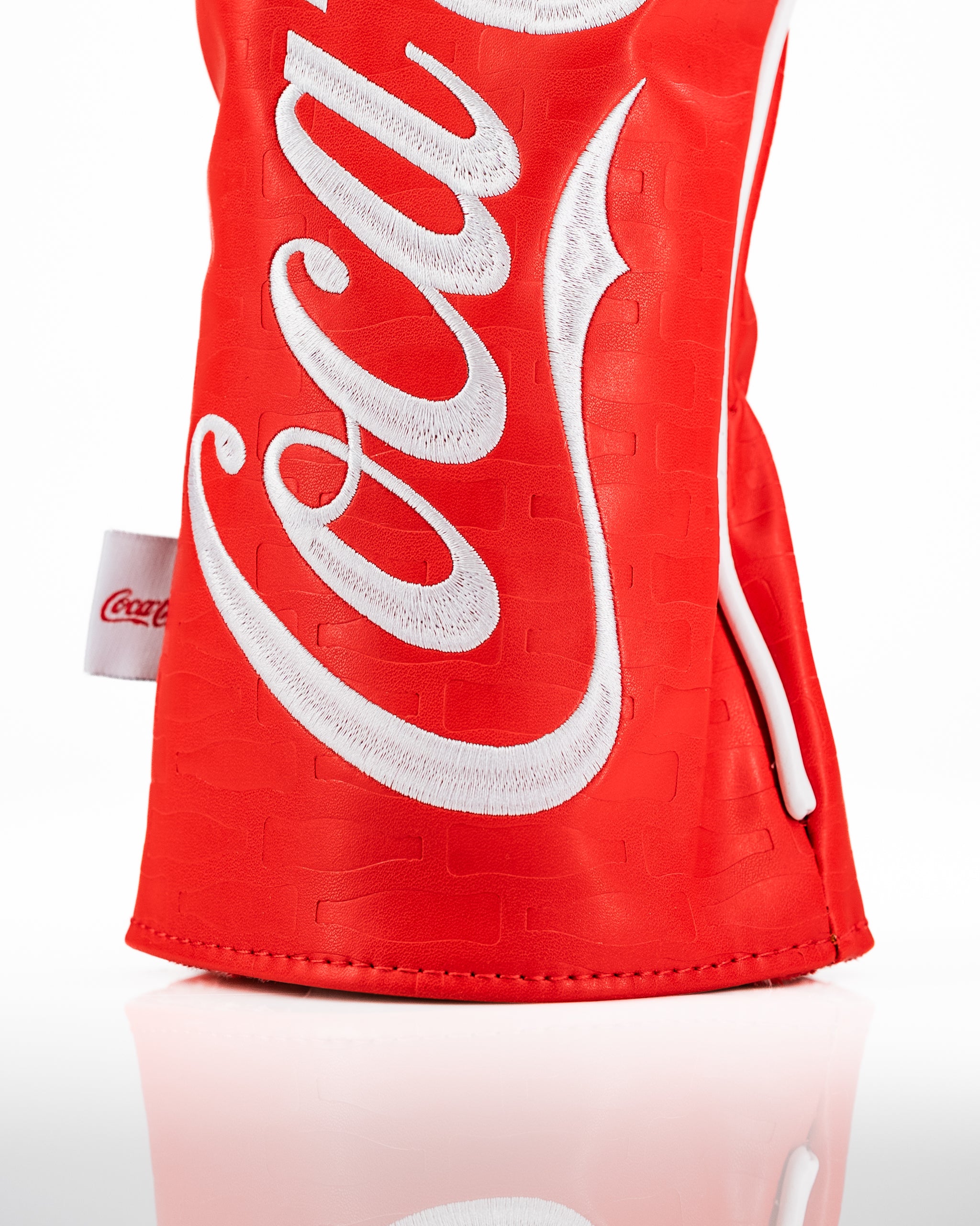 Coca-Cola driver cover in vibrant red with white logo, designed for golfers seeking a bold accessory on the course.