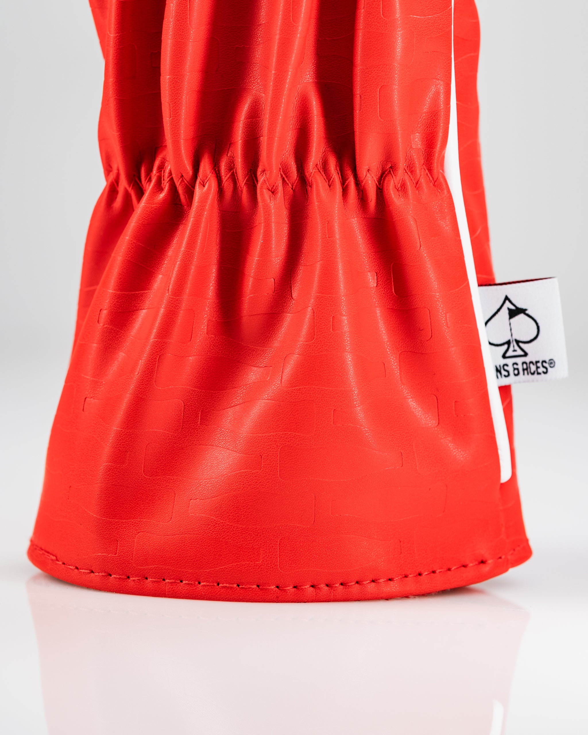 Bold red driver cover featuring a textured design and a white stripe, perfect for golfers wanting to showcase their style.