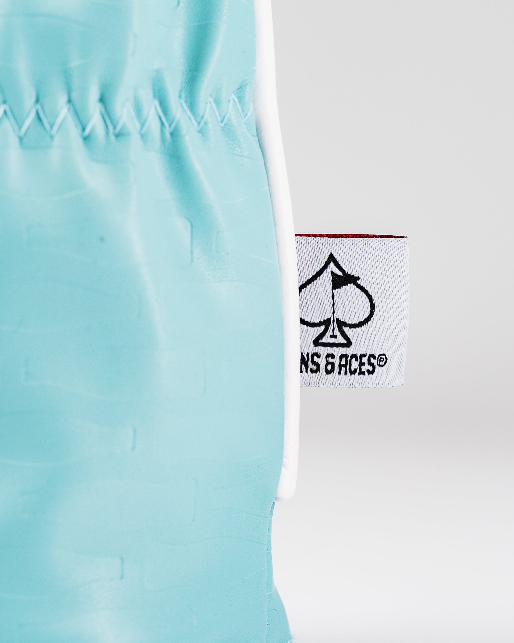 Coca-Cola themed fairway cover in vibrant teal with a logo tag from Pins and Aces for stylish golf protection.