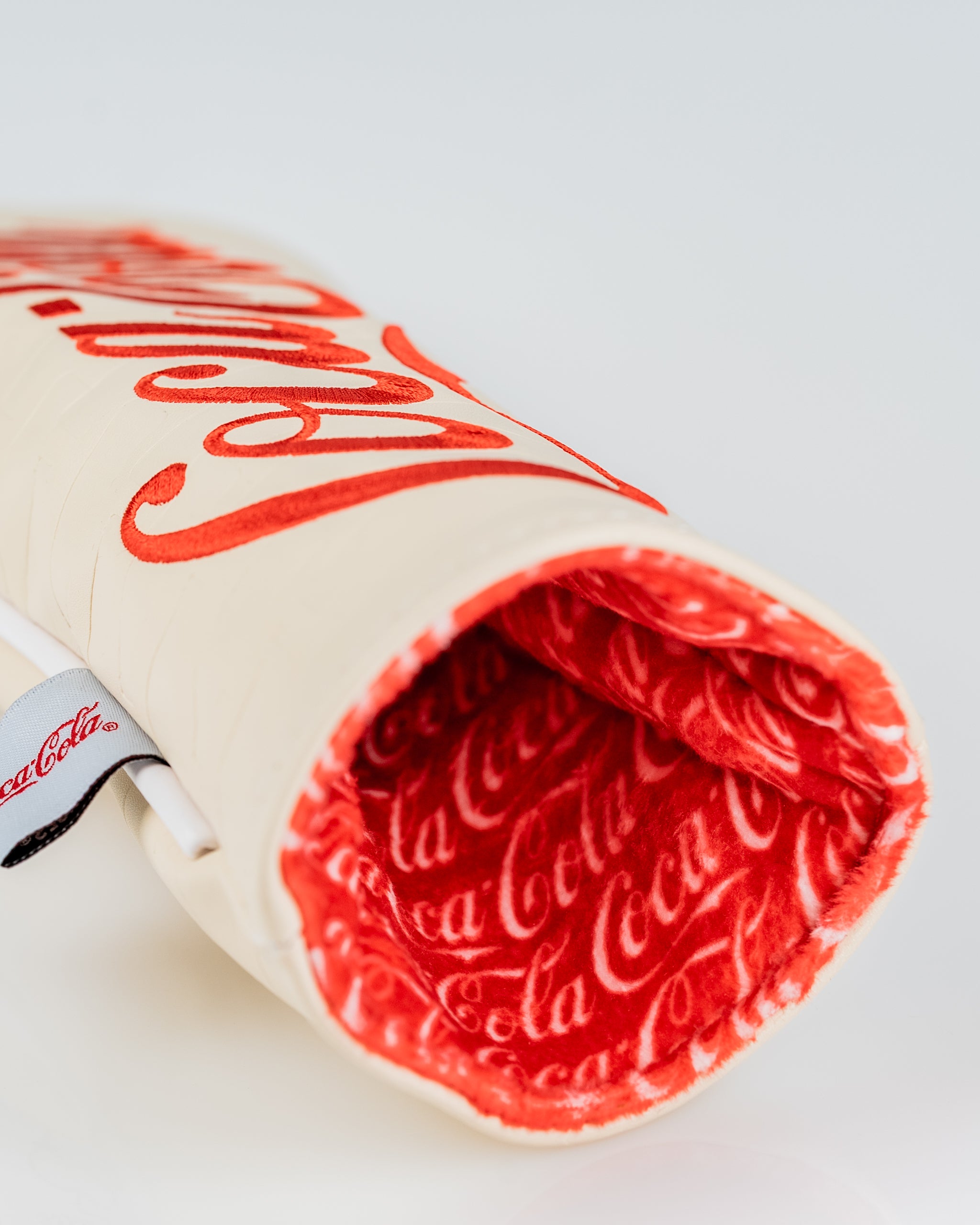 Coca-Cola hybrid golf headcover featuring a bold logo design and a plush red interior for added protection.