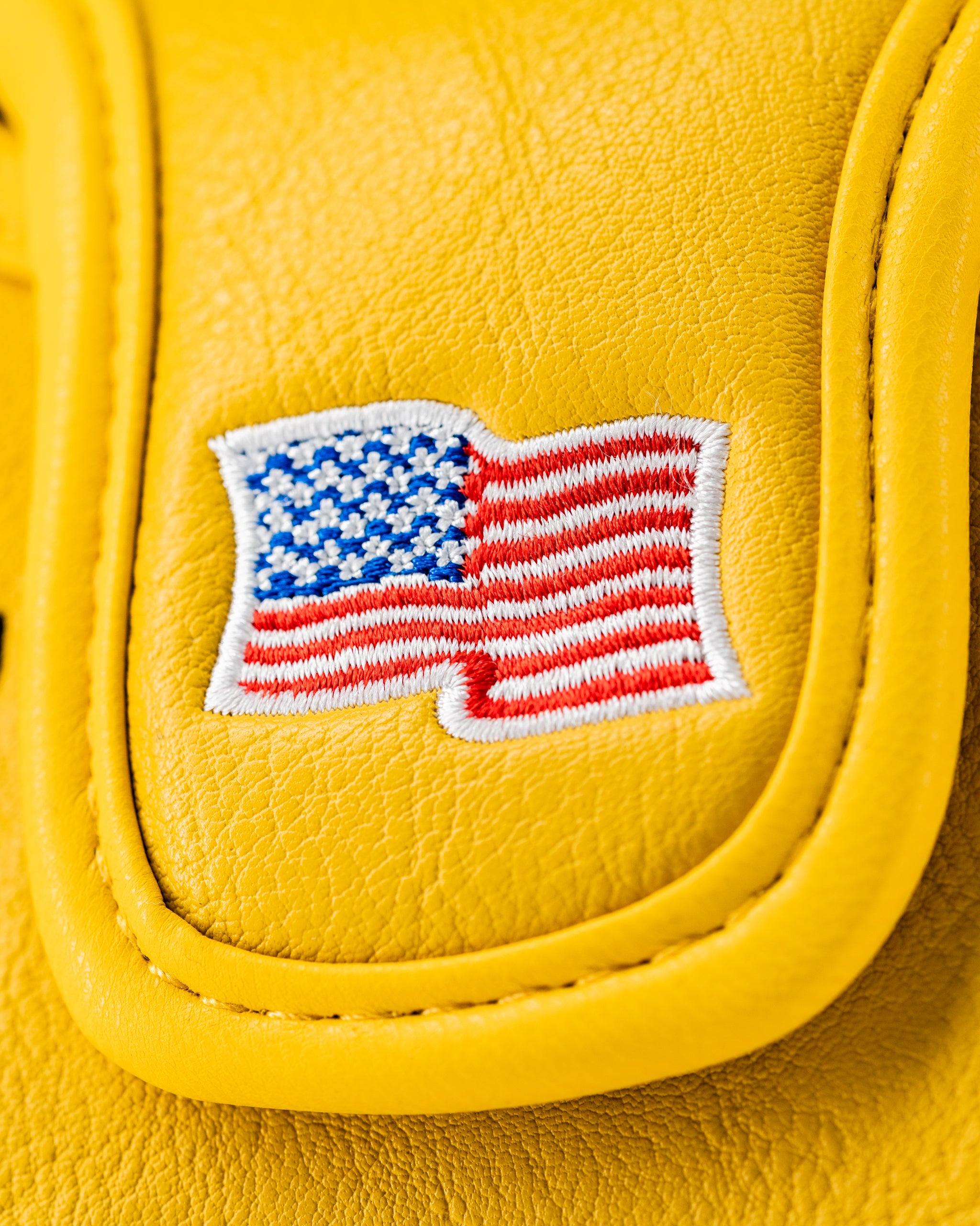 Bold yellow mallet putter cover featuring an embroidered American flag design, perfect for standout golf style.