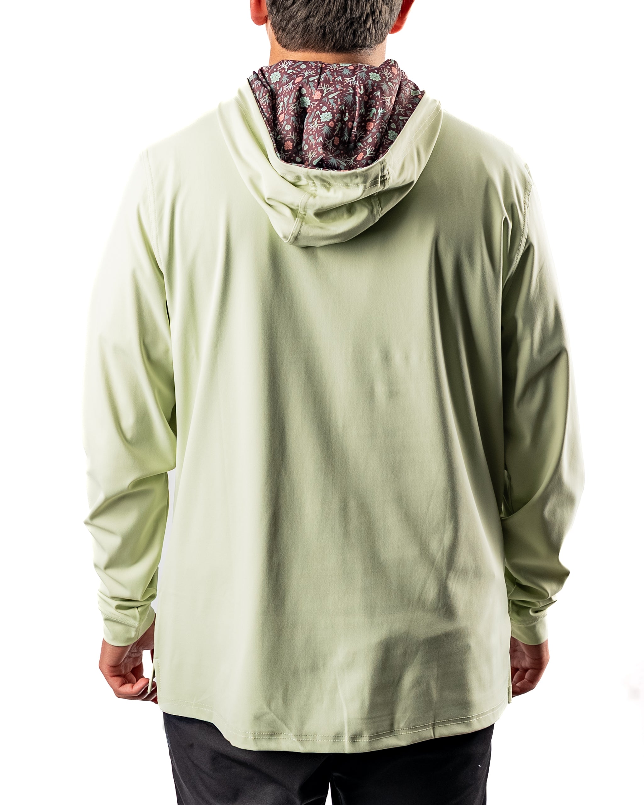 Men's performance golf hoodie in desert sage, featuring a patterned interior hood, designed for comfort on the course.