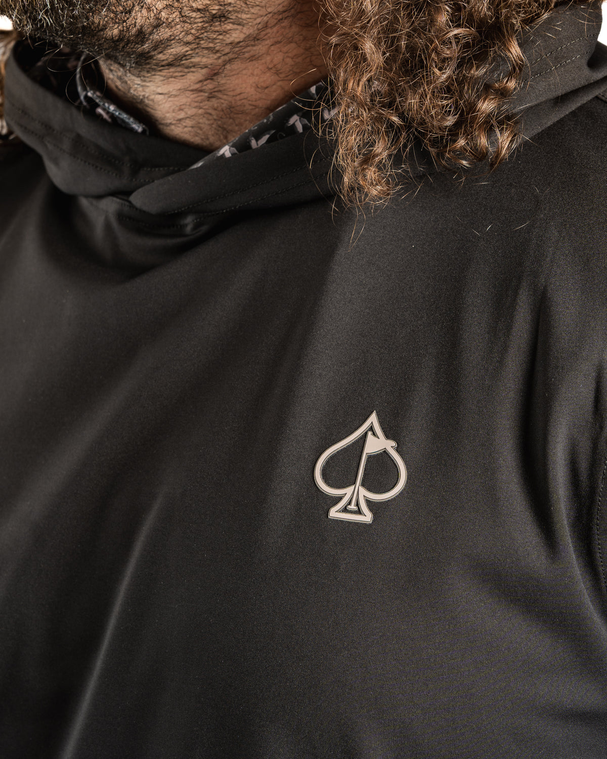 Men's performance golf hoodie in black featuring a sleek duck hook design and a stylish logo on the chest.