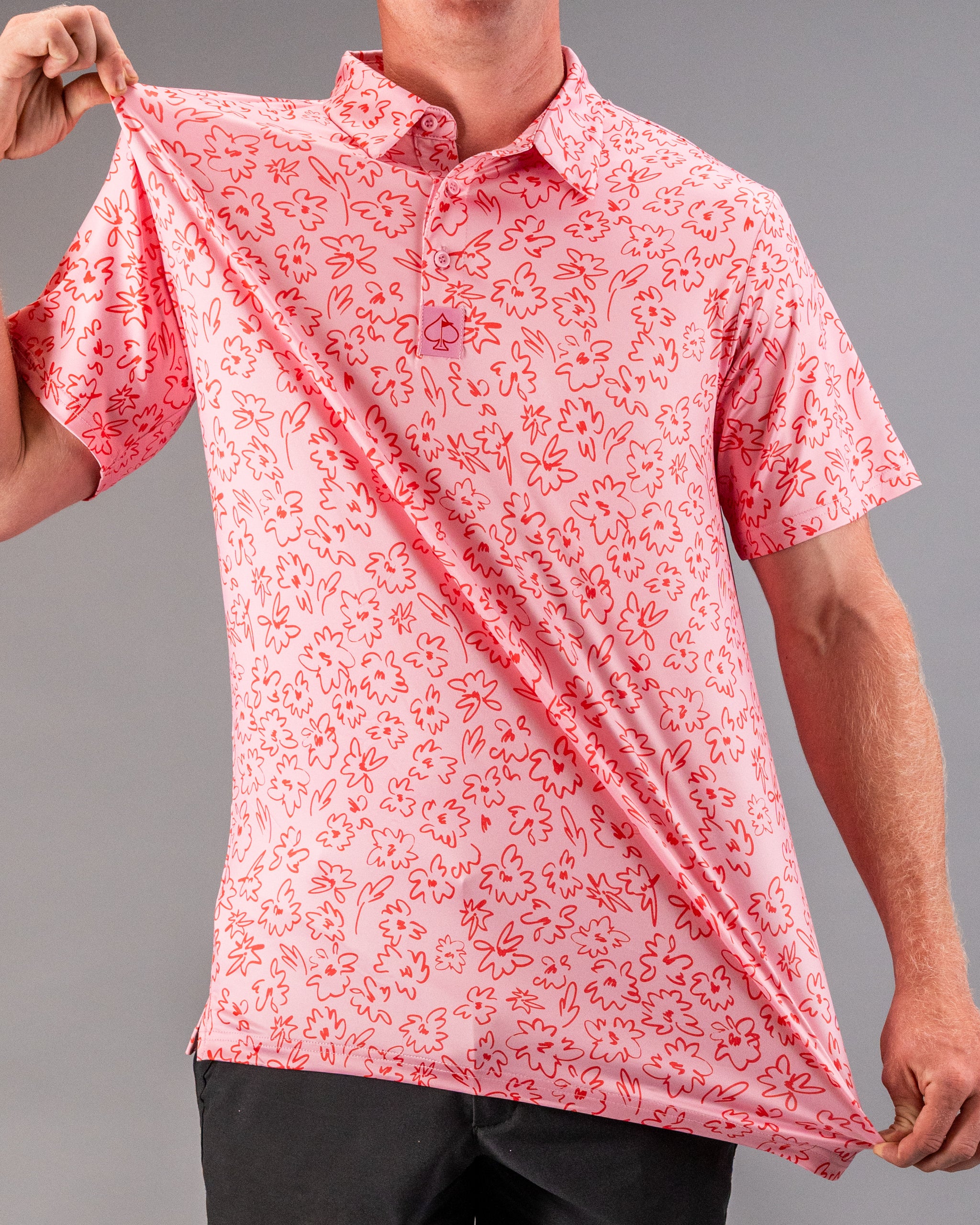 Men's pink golf polo featuring a playful flower doodle pattern, perfect for adding style on the course.
