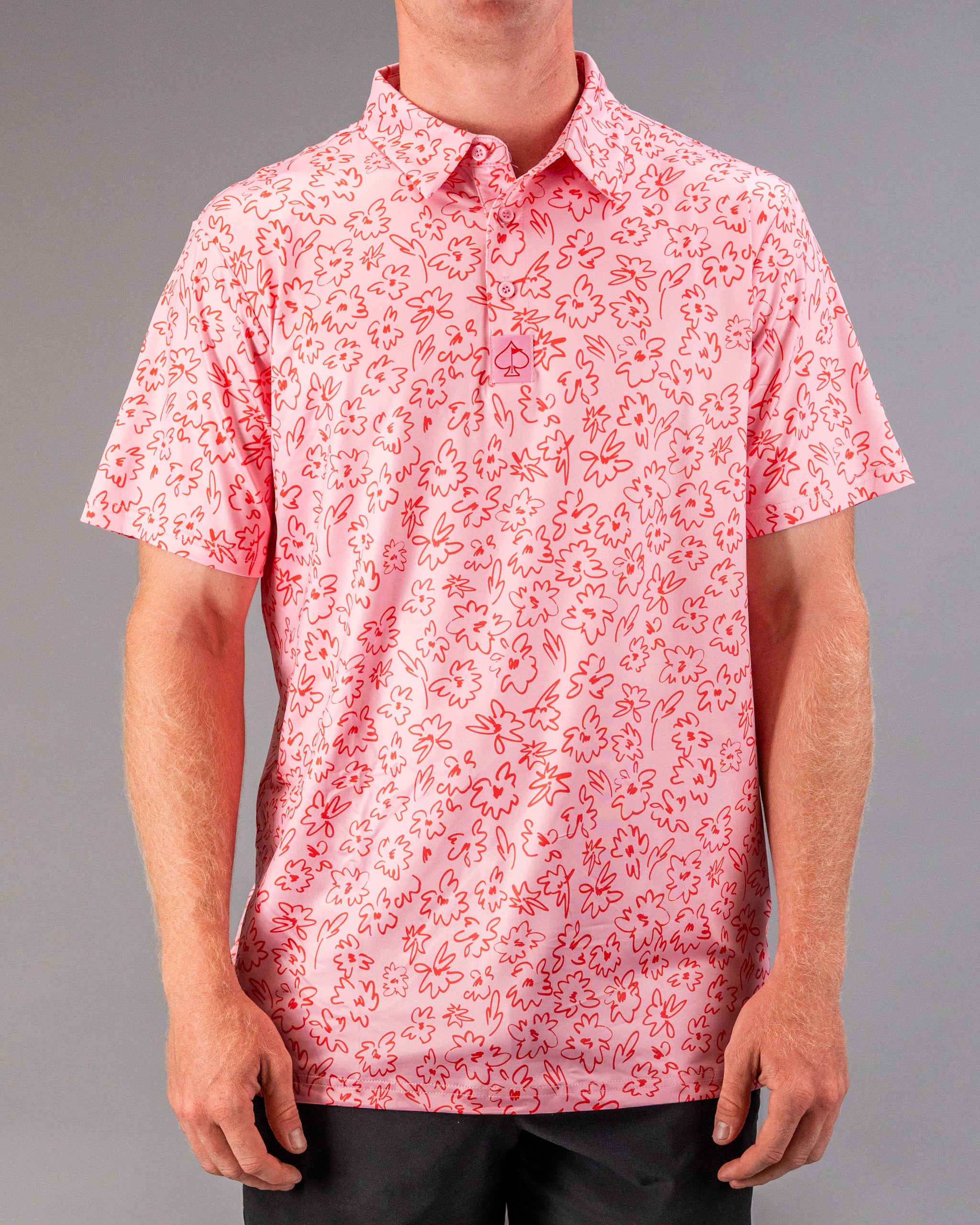 Men's short-sleeve golf shirt in pink with a playful flower doodle pattern, perfect for a stylish day on the course.