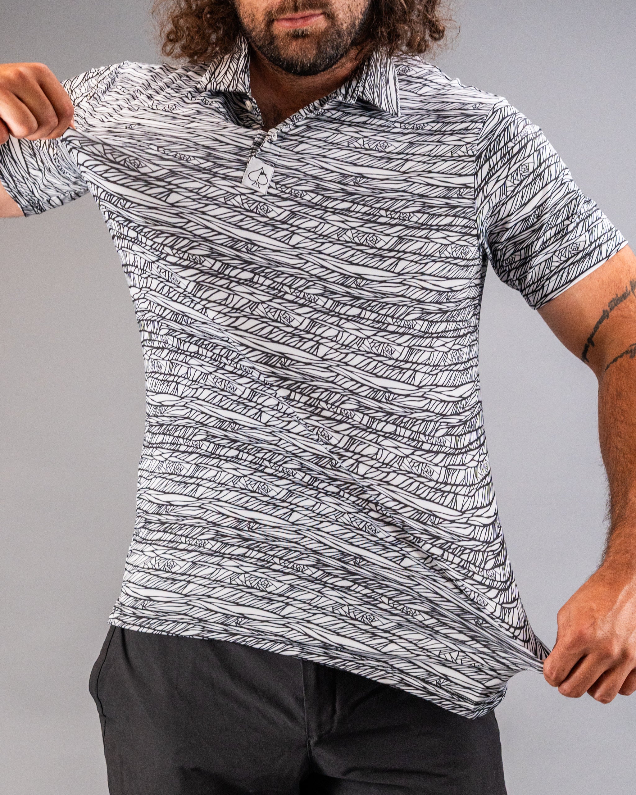 Bold black and white golf polo featuring a unique abstract pattern, perfect for stylish golfers on the course.