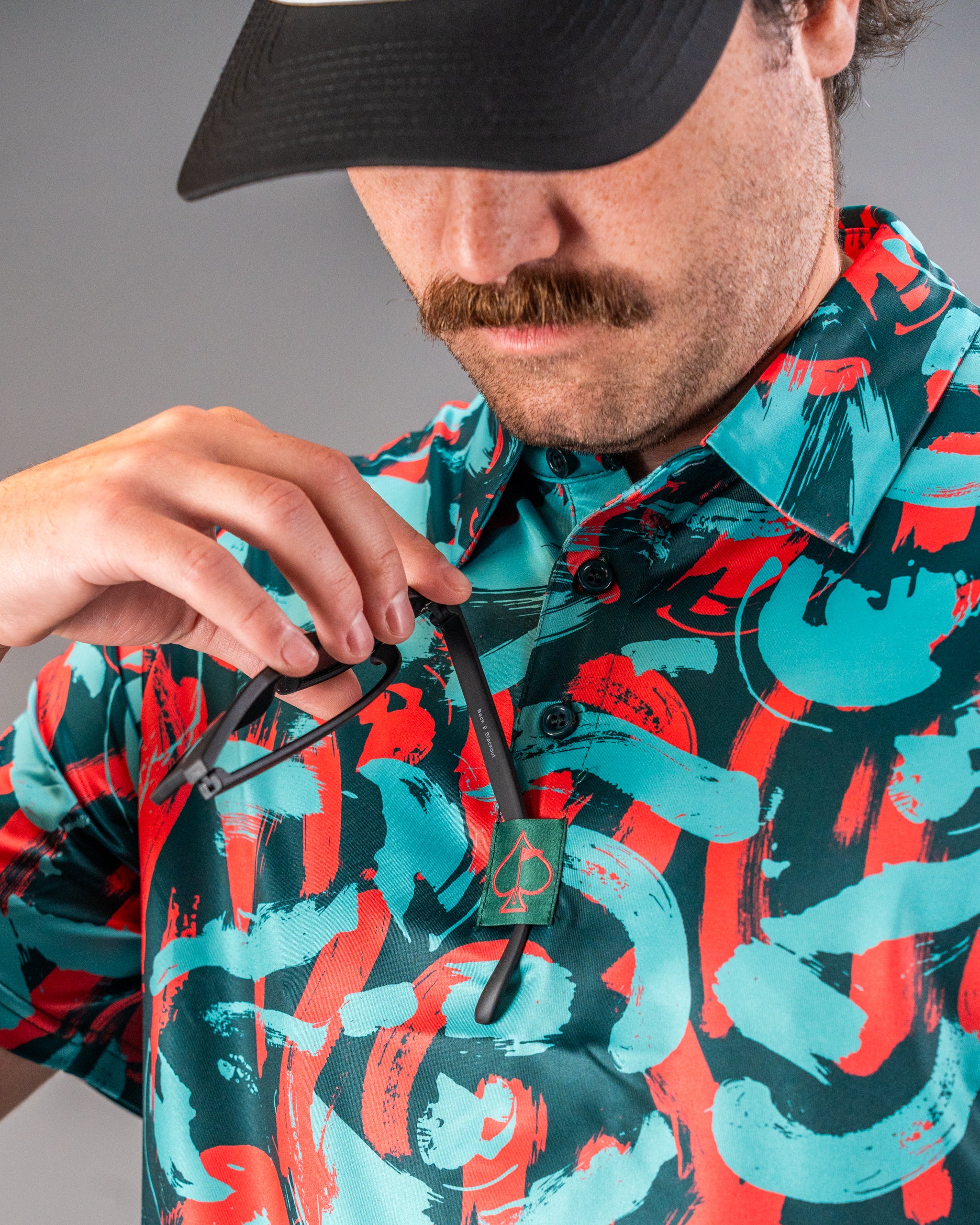 Bold Paint Strokes Coral golf shirt featuring vibrant colors and unique patterns, perfect for stylish golfers.