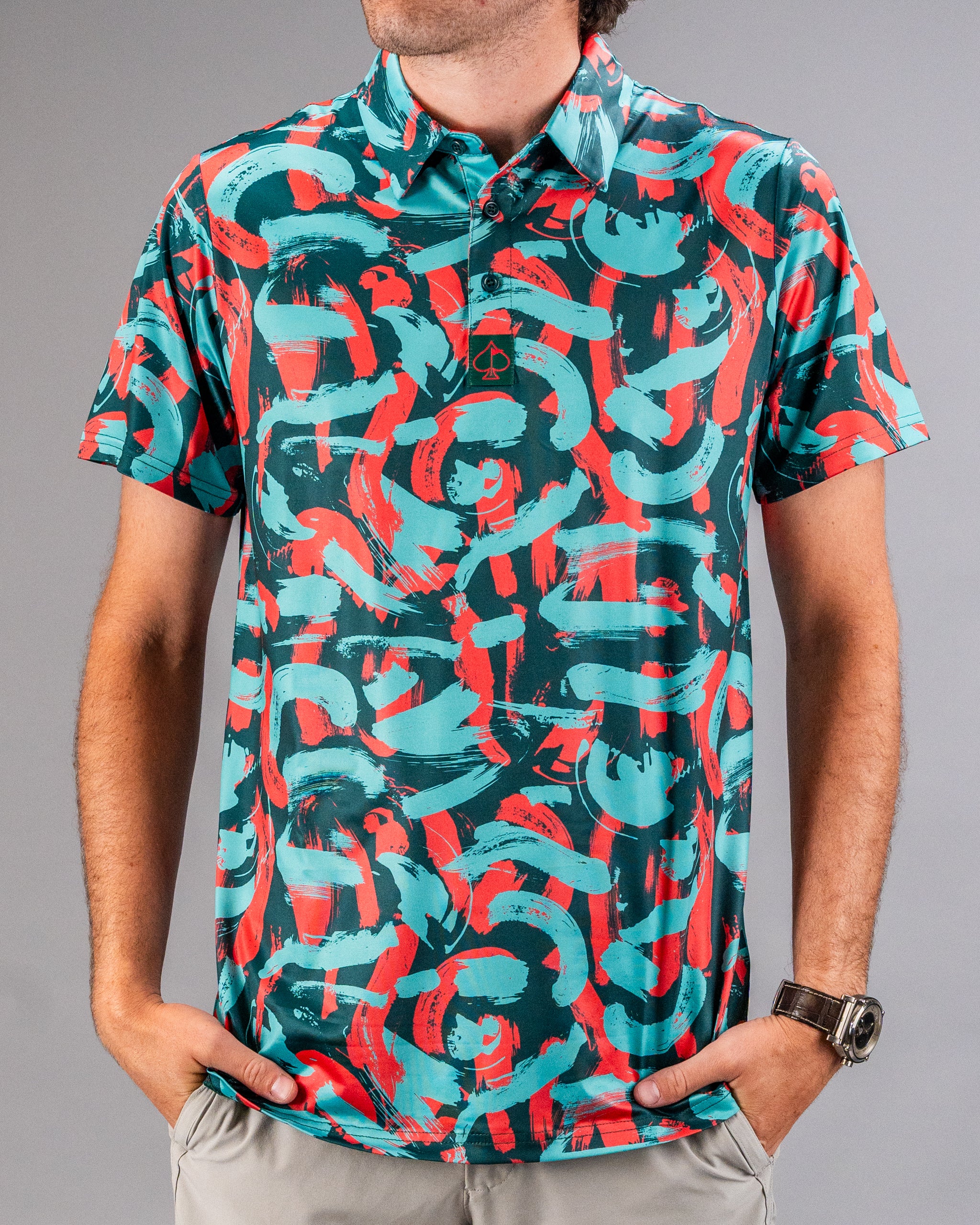 Bold golf polo featuring a vibrant coral and teal paint stroke pattern, perfect for golfers looking to stand out on the course.