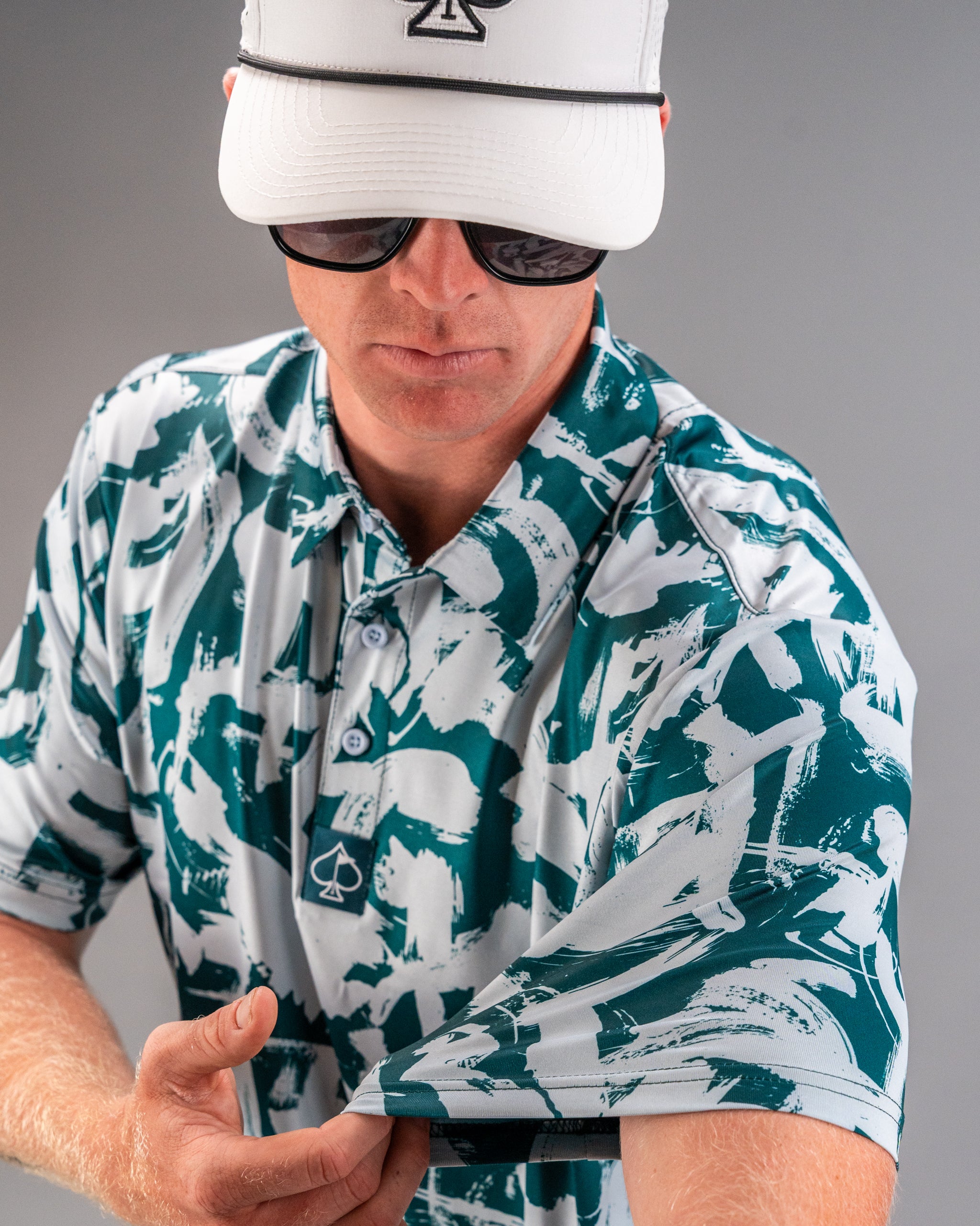 Bold golf shirt featuring a green and white paint stroke pattern, perfect for golfers looking to make a statement on the course.