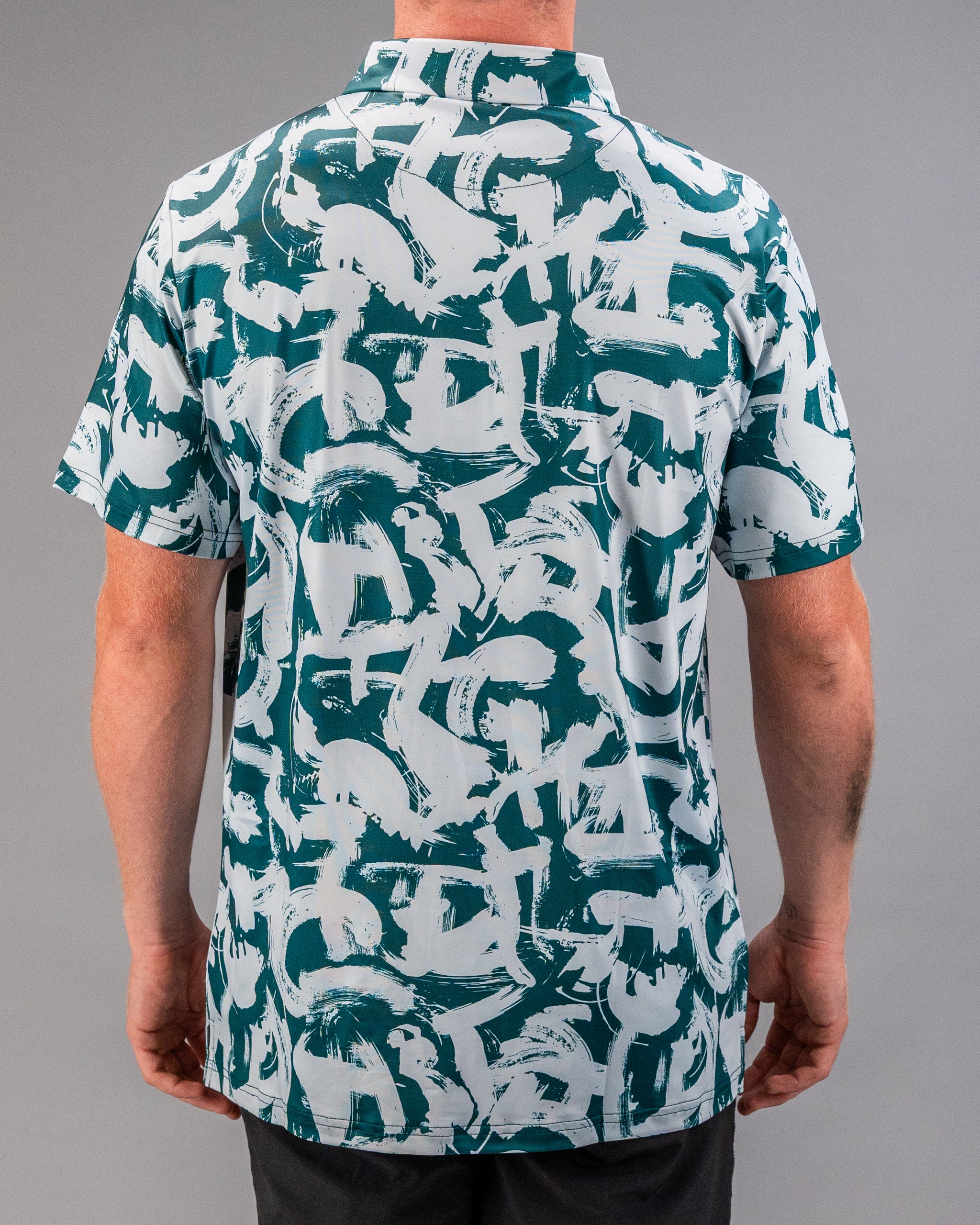 Men's short-sleeve golf shirt featuring a bold green and white paint stroke pattern, perfect for a standout look on the course.
