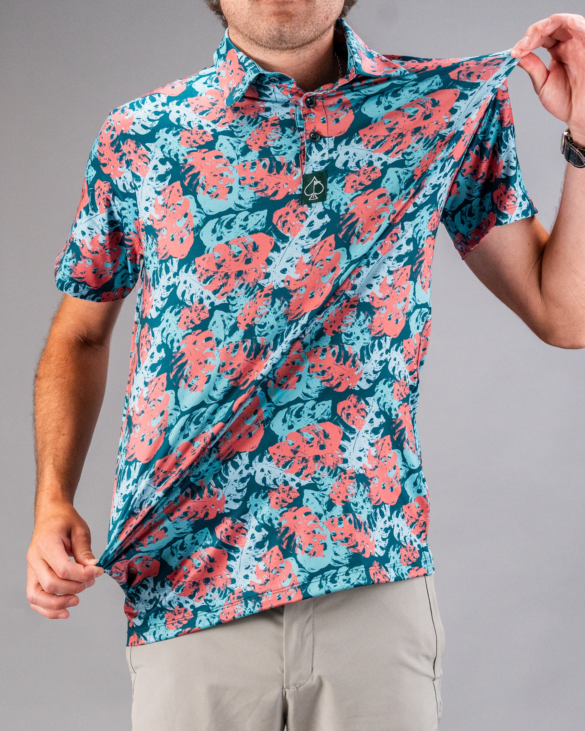 Bright blue and coral floral golf shirt with bold, tropical print for golfers who want to stand out on the course.