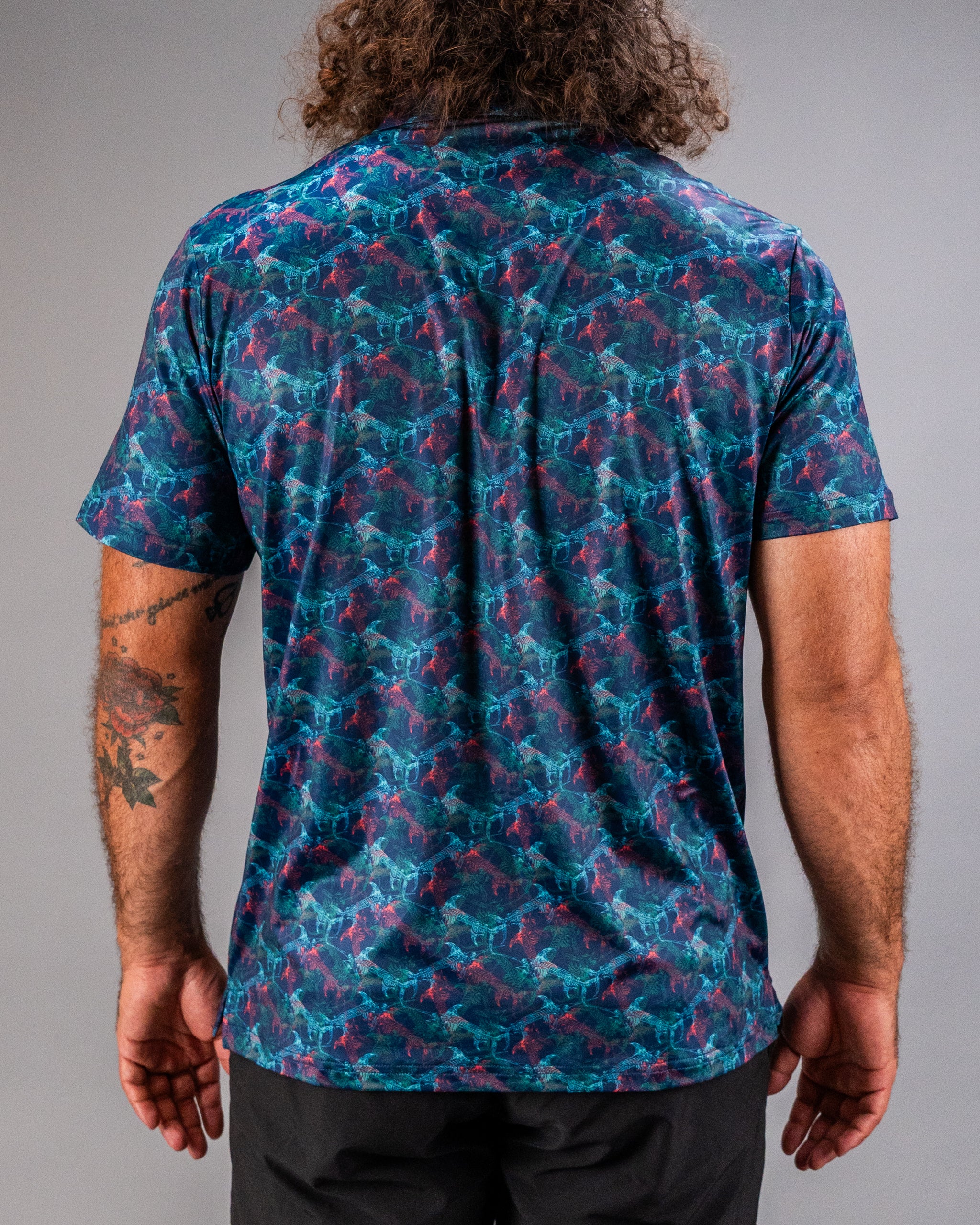 Men's Swordfish Skelly golf shirt featuring a vibrant, colorful fish pattern on a dark background, perfect for stylish golfers.
