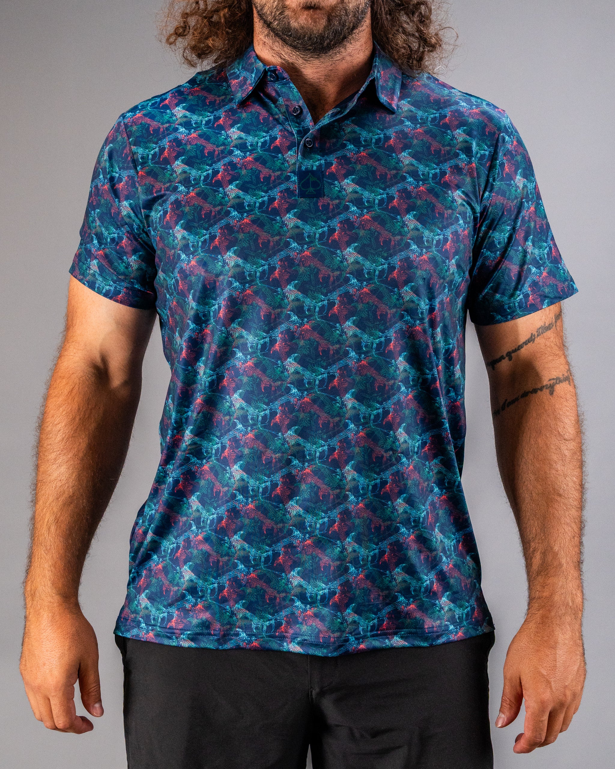 Bold golf polo featuring a vibrant swordfish pattern in shades of blue and purple, designed for stylish performance on the course.