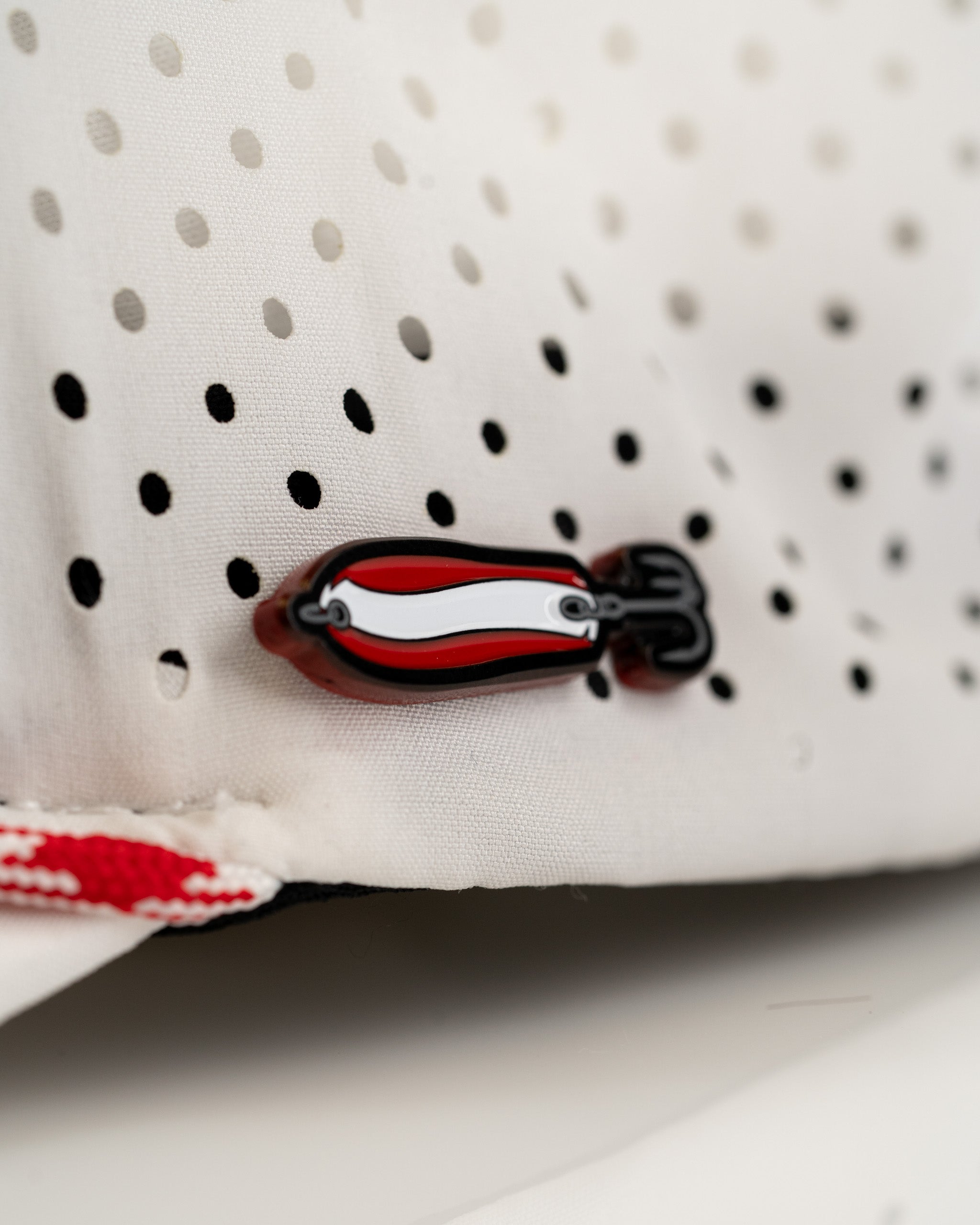 White perforated rope hat featuring a bold Dare Devil Spoon design, perfect for stylish golfers seeking standout accessories.