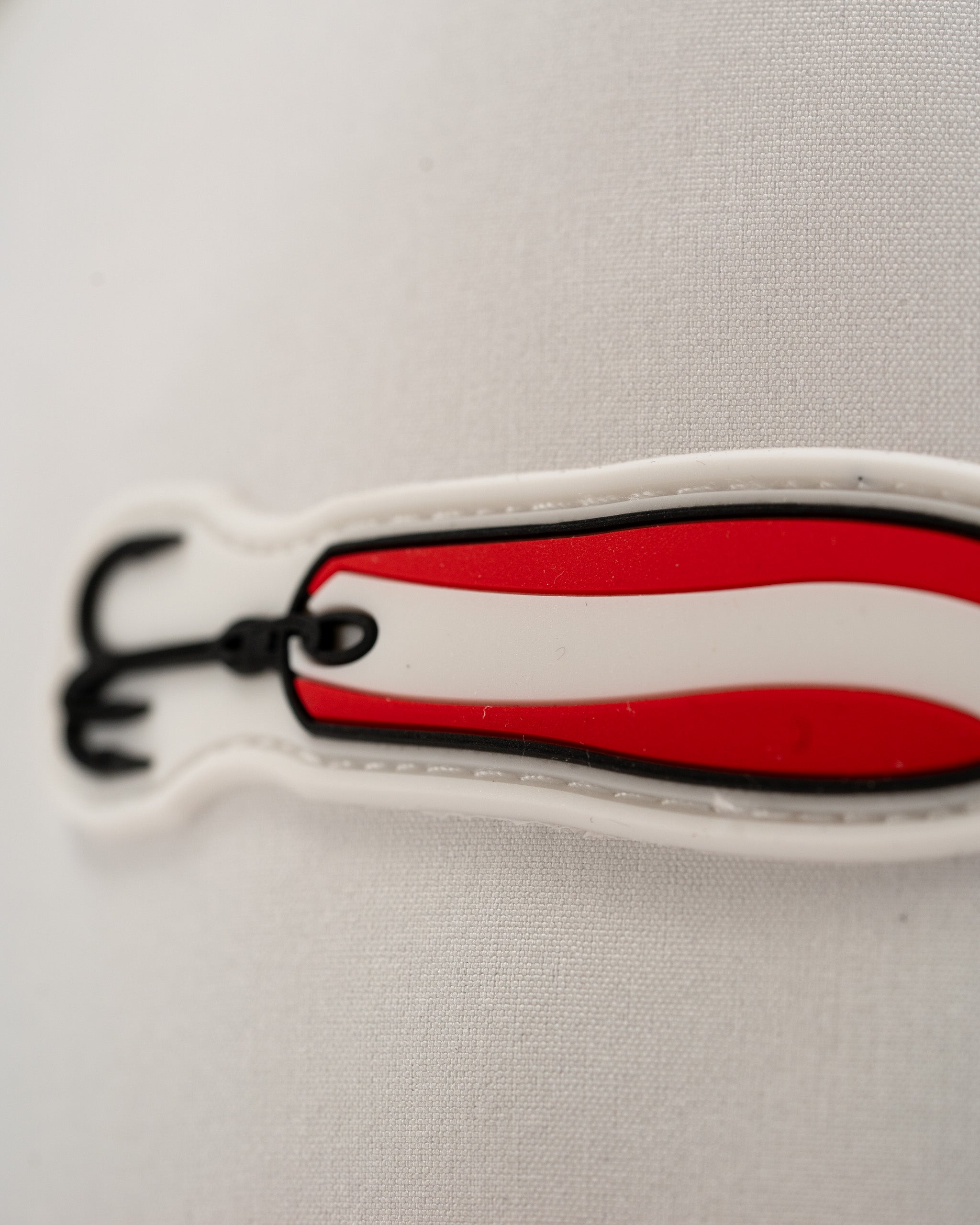 Bold white perforated rope hat featuring a red and black Dare Devil Spoon design, perfect for stylish golfers.