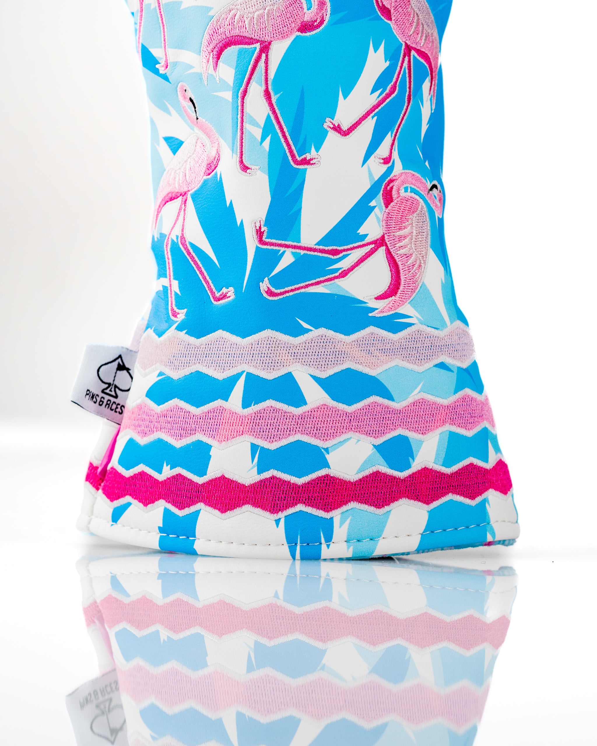 Bright blue headcover featuring vibrant pink flamingos and playful patterns, perfect for adding flair to your golf bag.