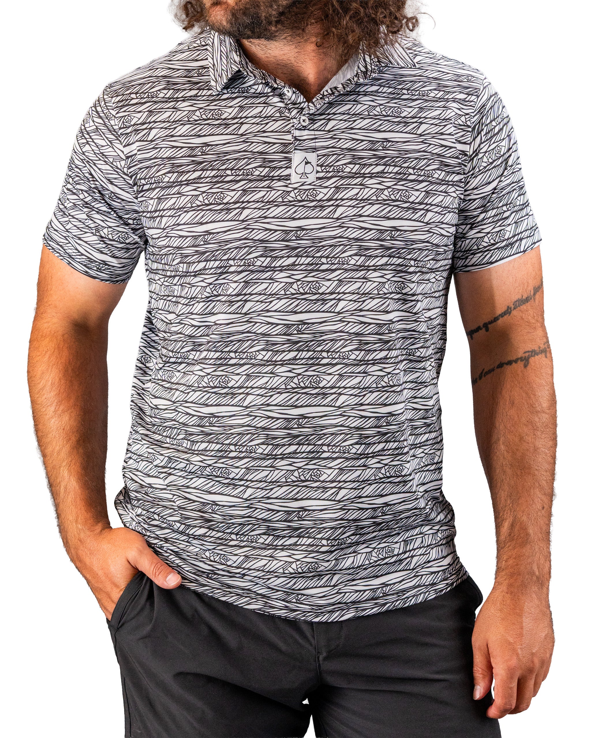 Men's Fragment Black golf polo featuring a bold, abstract pattern in black and white, designed for stylish performance on the course.
