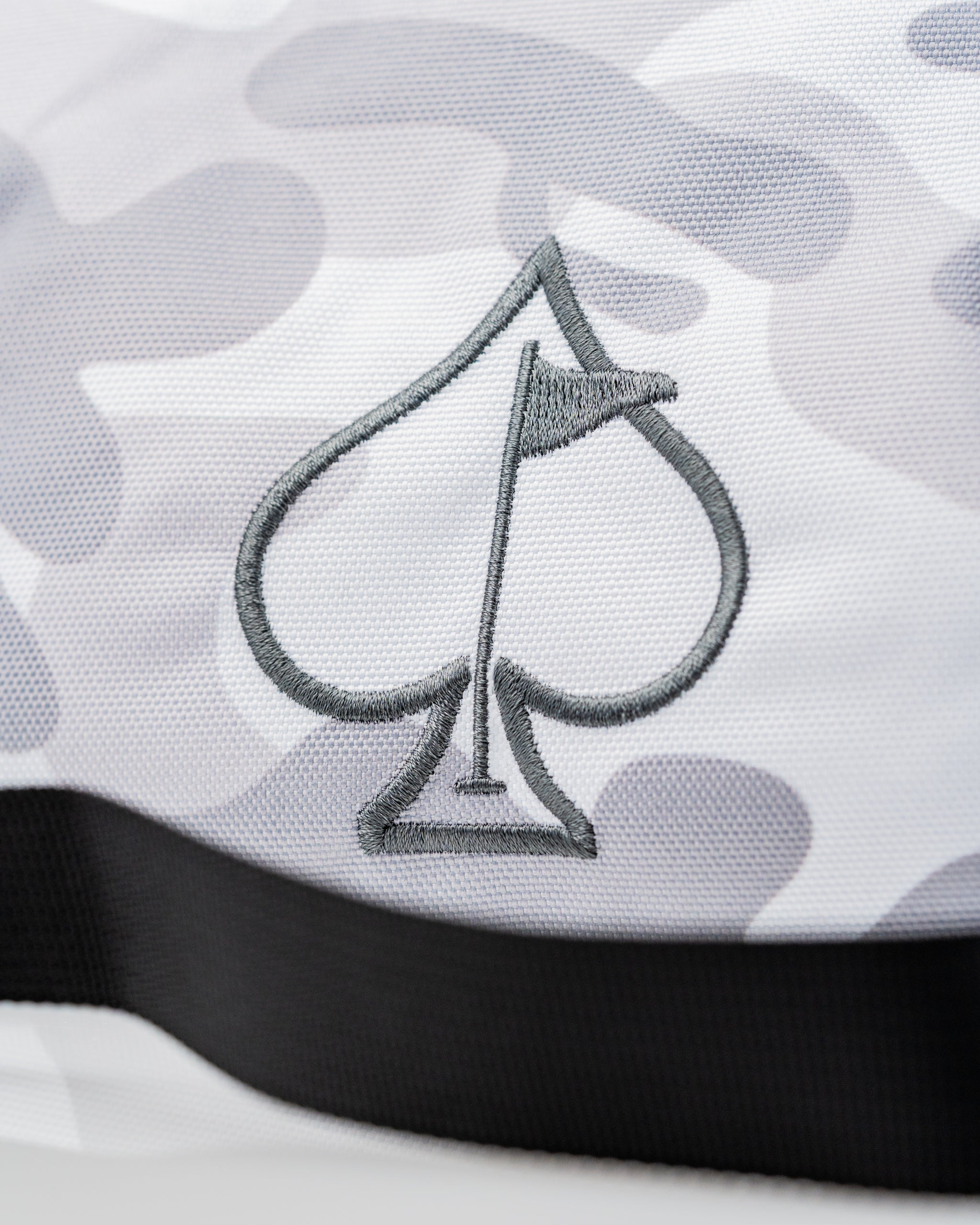 Pins and Aces X G-Tech Electric Hand Warmer featuring a stylish spade logo on a camo-patterned fabric.