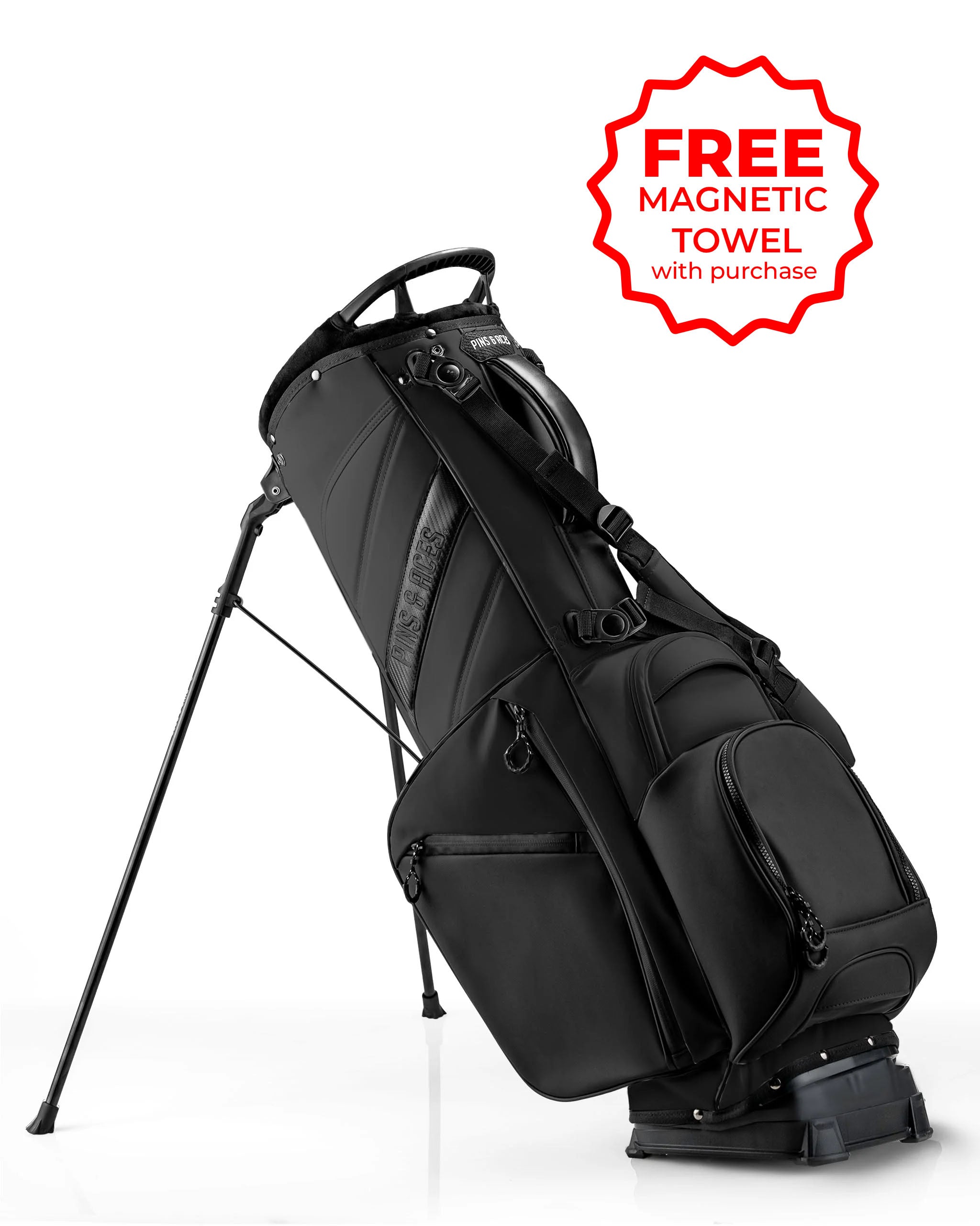 Sleek black Player Preferred Golf Bag with a stand, featuring multiple pockets and a promotional tag for a free magnetic towel.