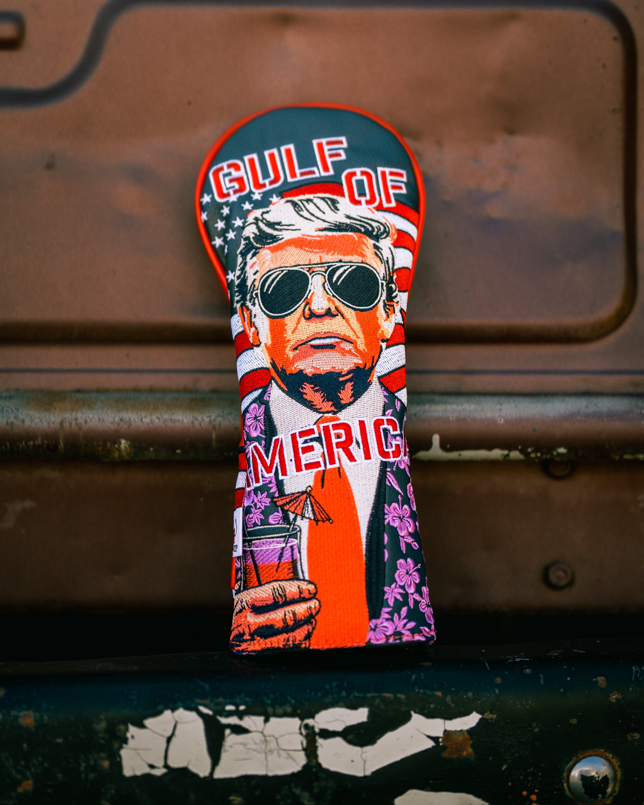 Bold golf fairway cover featuring a stylized illustration of a man in sunglasses with an American flag background and tropical elements.