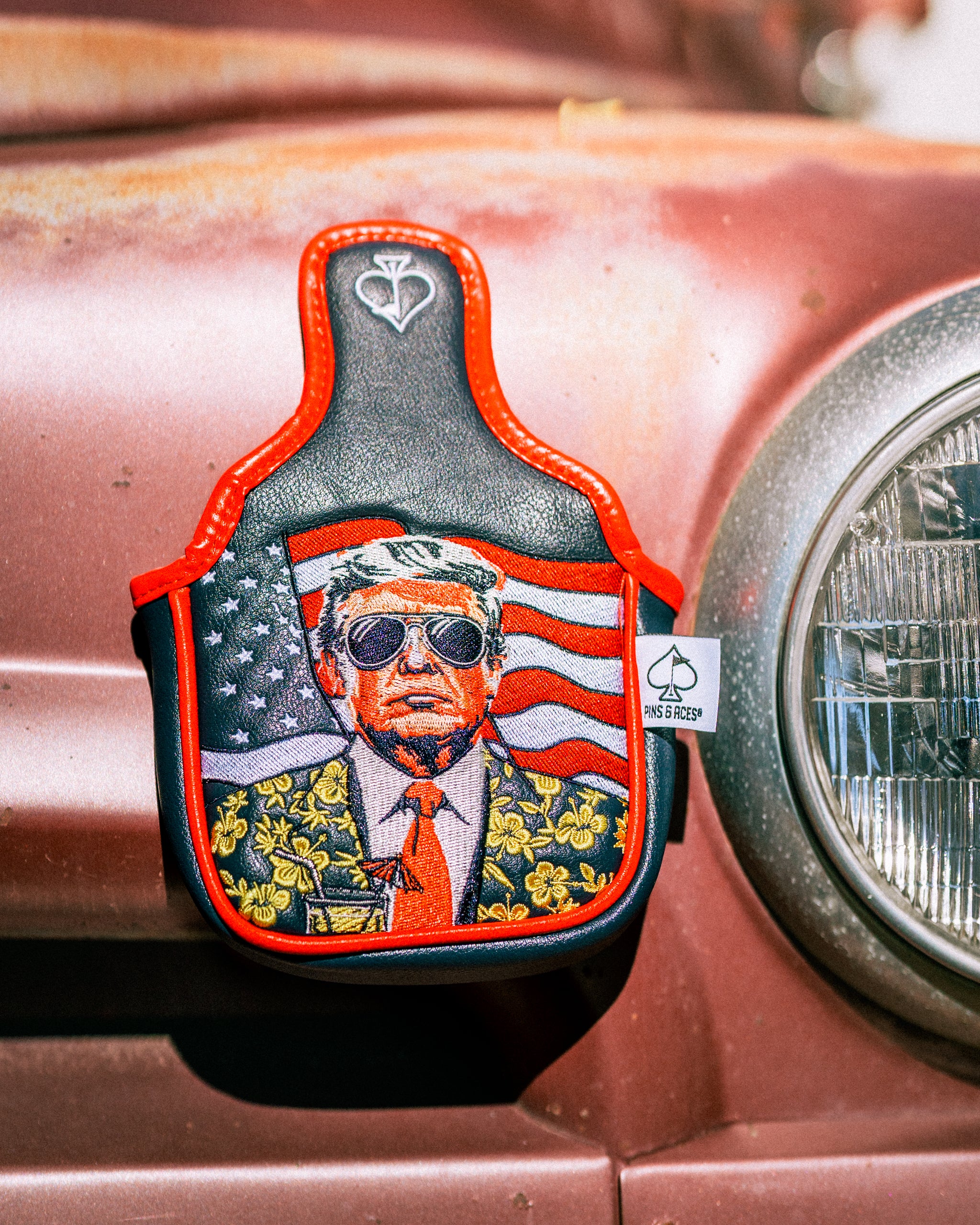 Bold mallet putter cover featuring a stylized design of a figure in sunglasses with an American flag backdrop.