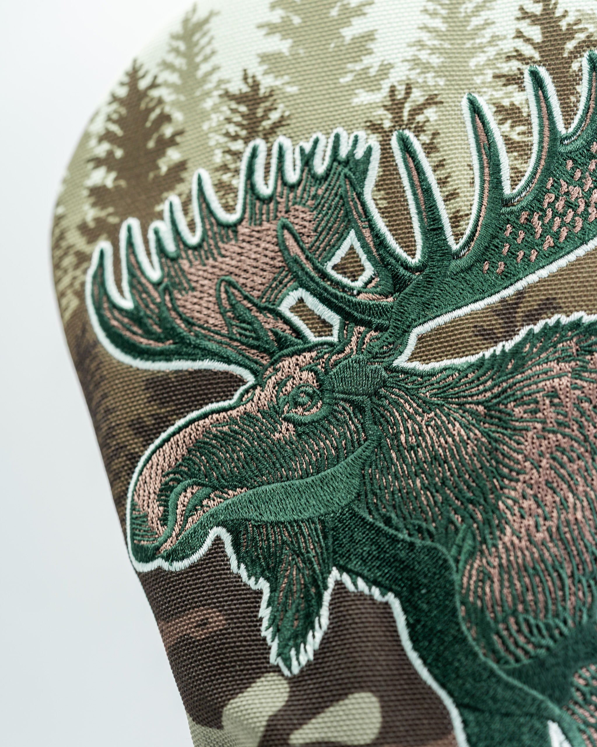 Moose driver cover featuring intricate embroidery and a camouflage background, perfect for bold golfers.